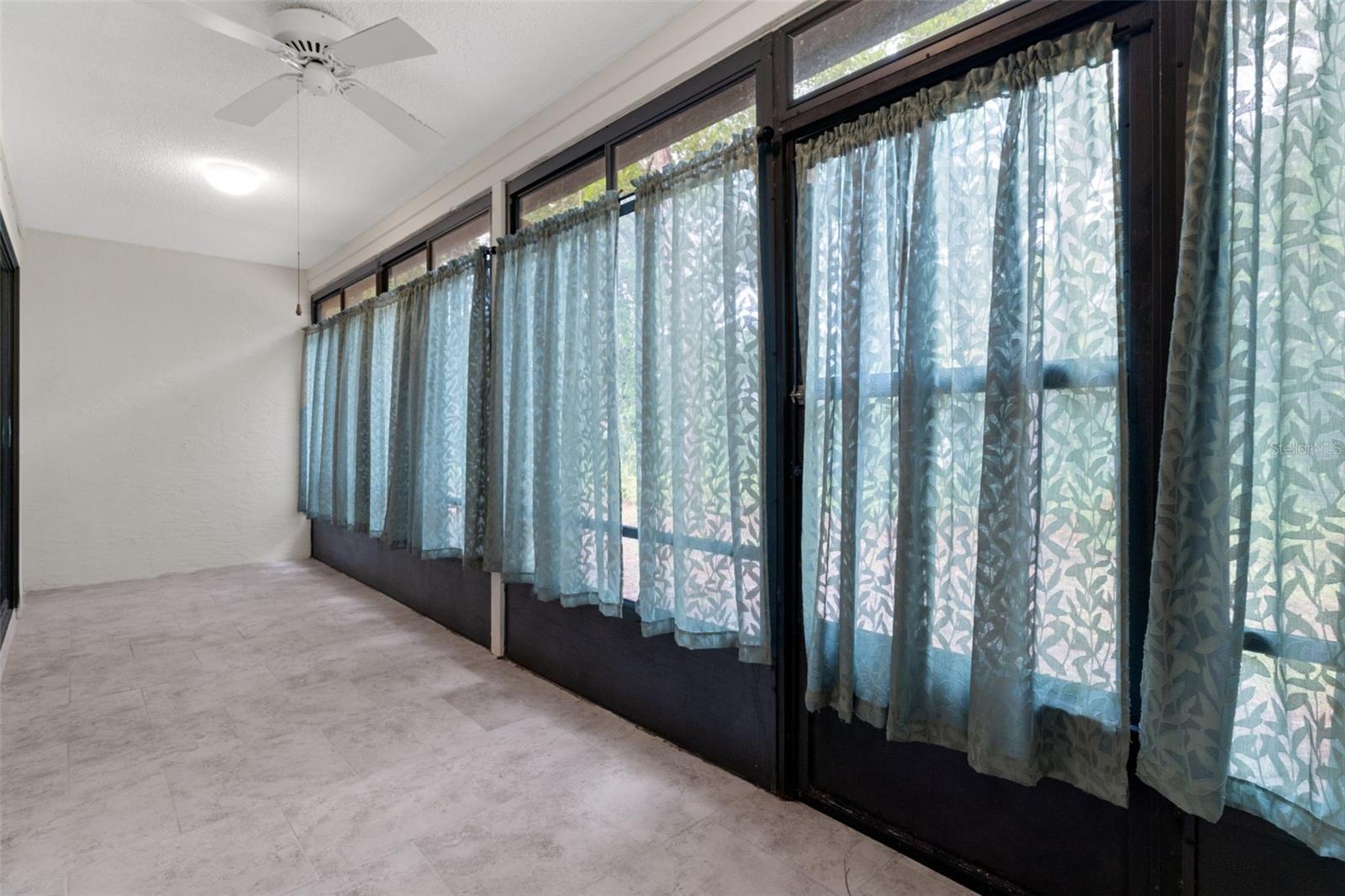 Enclosed by screen porch with sliding windows