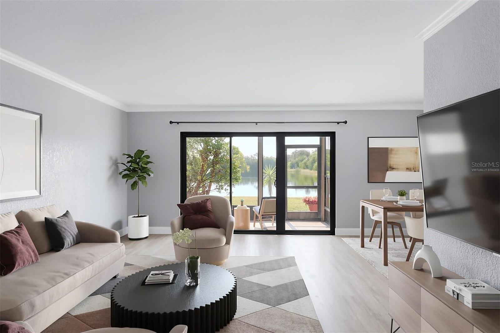 Virtually staged living/dining area with pond views