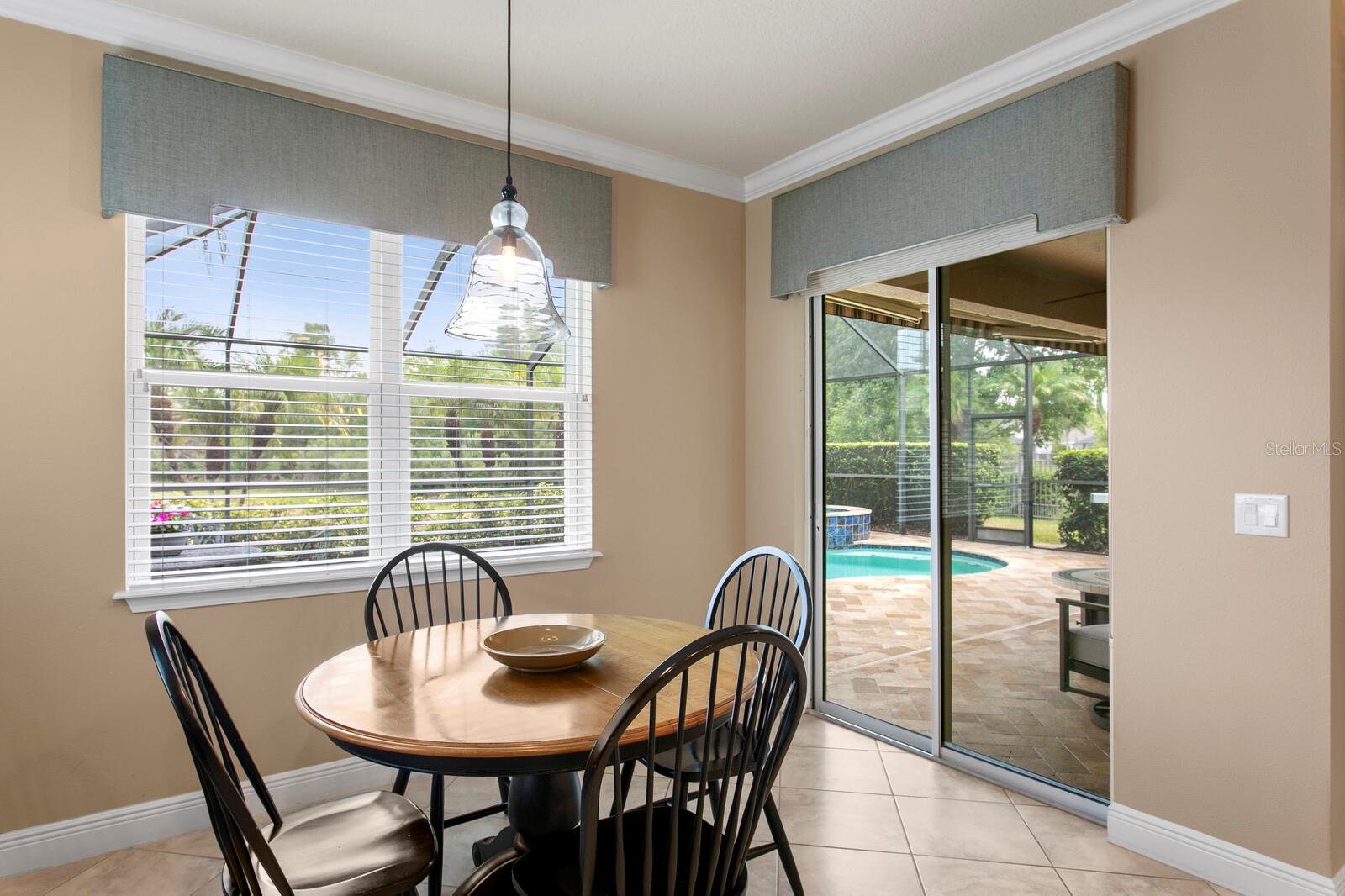 Backyard pool access from the casual dining area