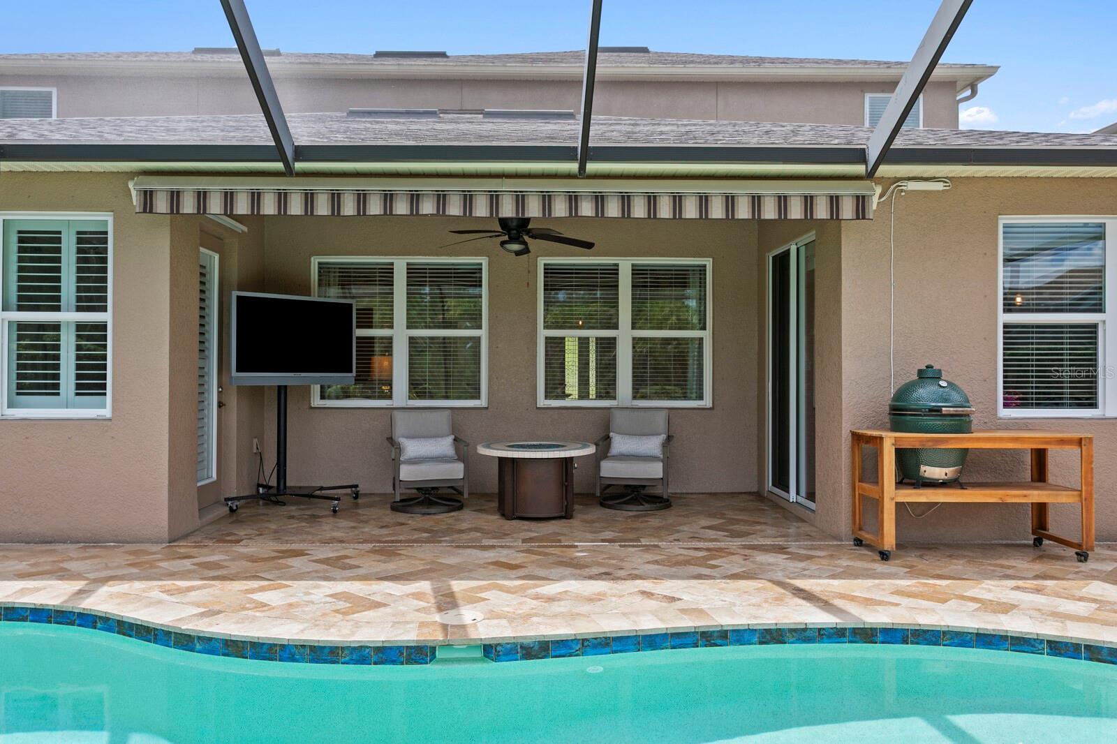 Covered lanai with ceiling fan and a powered retractable Sunsetter awning for additional shaded space