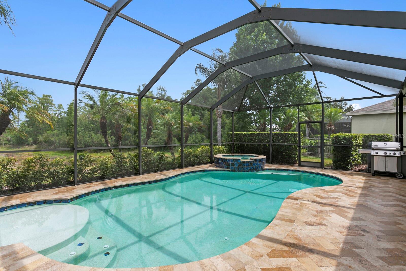 Gorgeous travertine pavers on the expansive pool deck