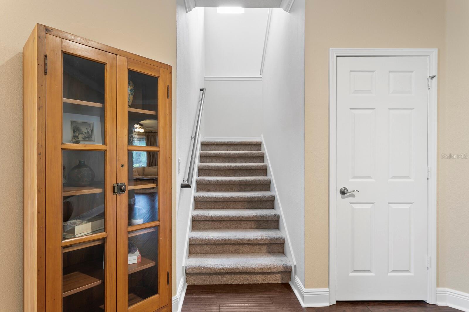 Split staircase to 2nd floor and understairs storage closet