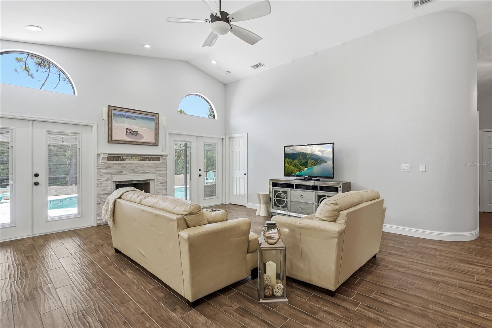 Extremely spacious living room can house large furniture and an enormous wall mounted TV.
