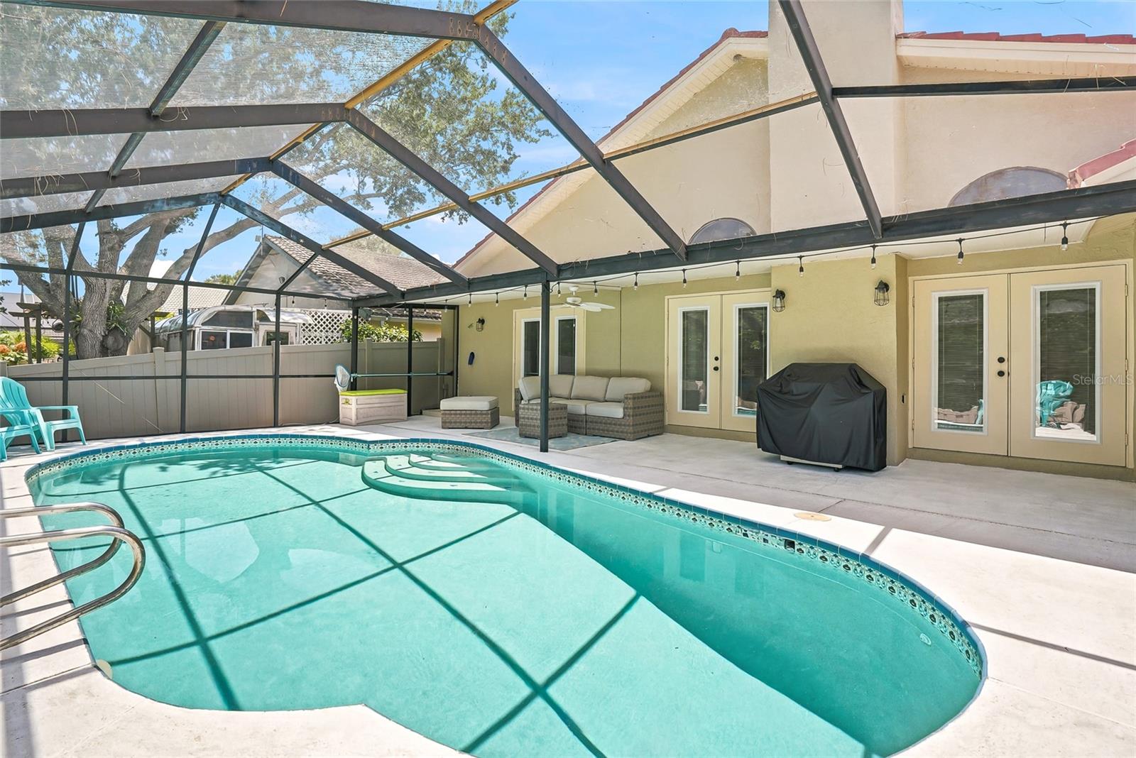 Gorgeous pool with a screened lanai with plenty of spaces for shade and sun.