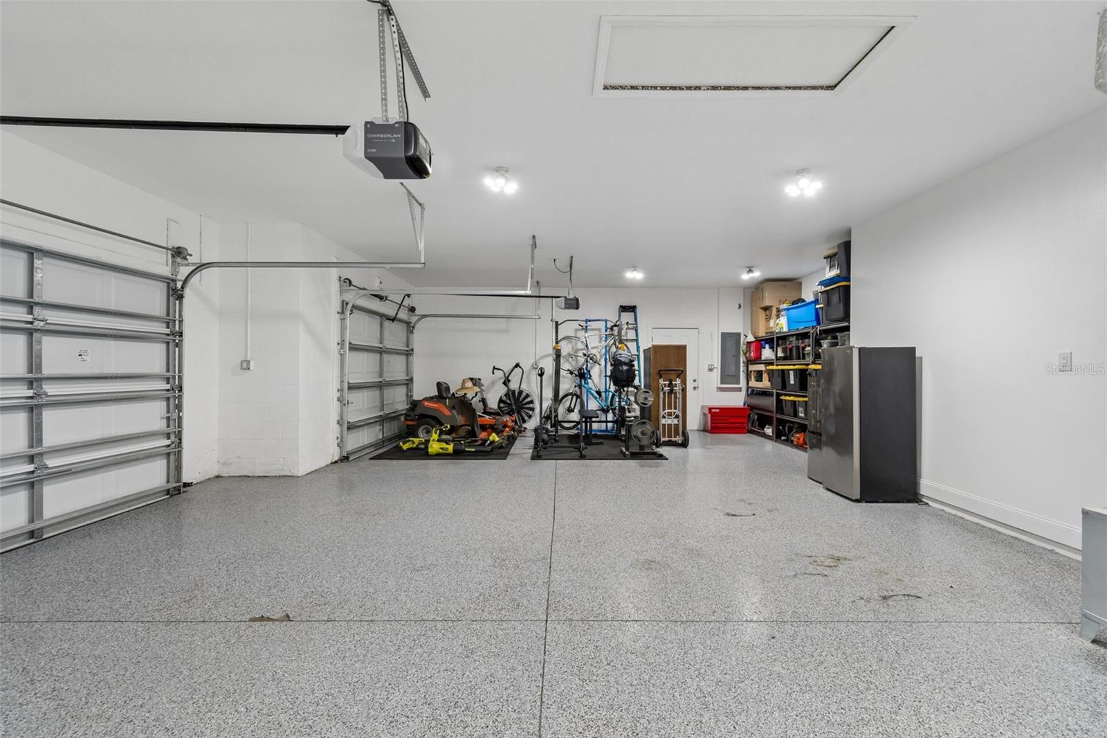 massive 3 car garage with epoxy floor and EV charger