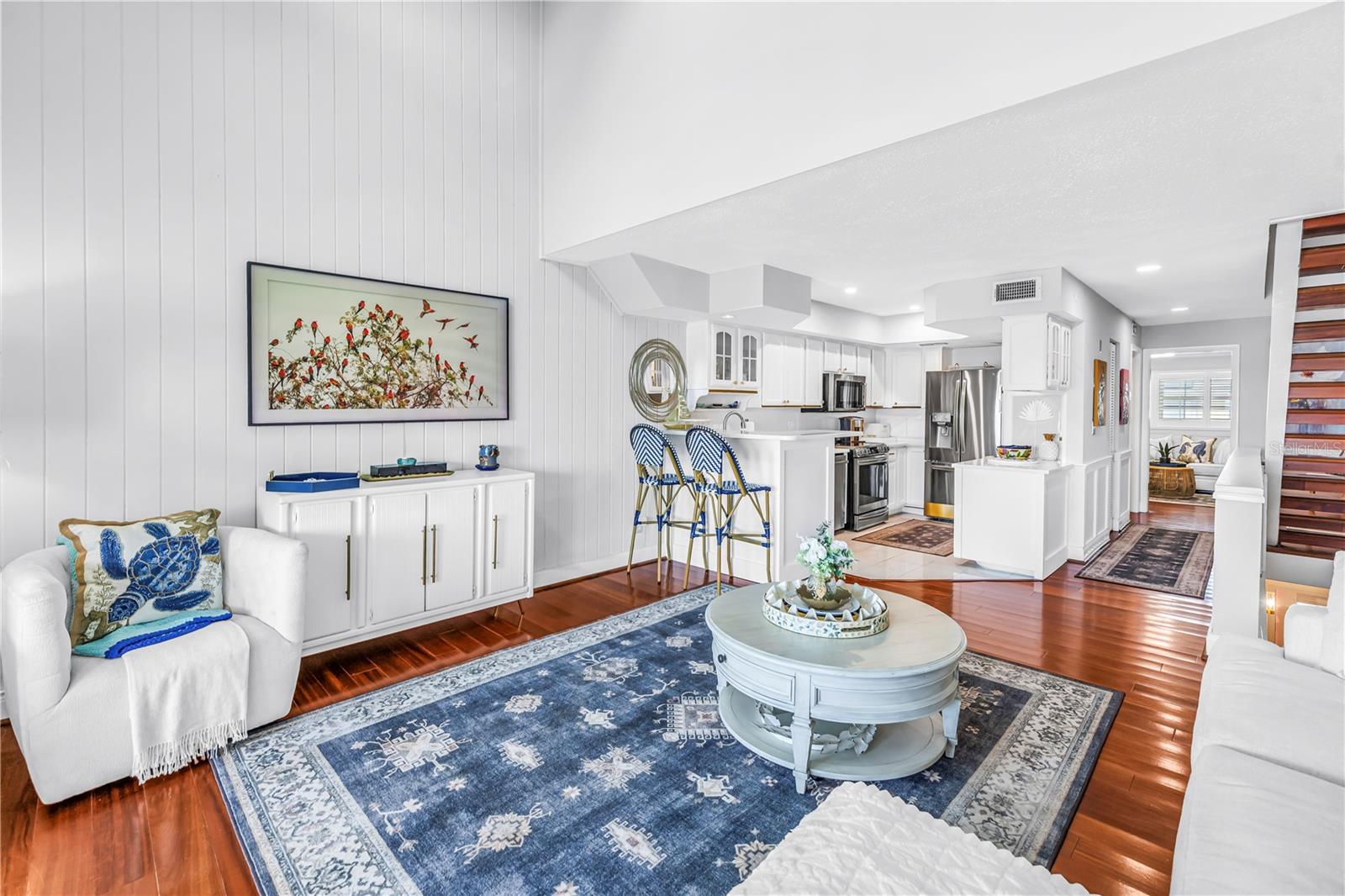 Open concept living to light and bright gold accented kitchen