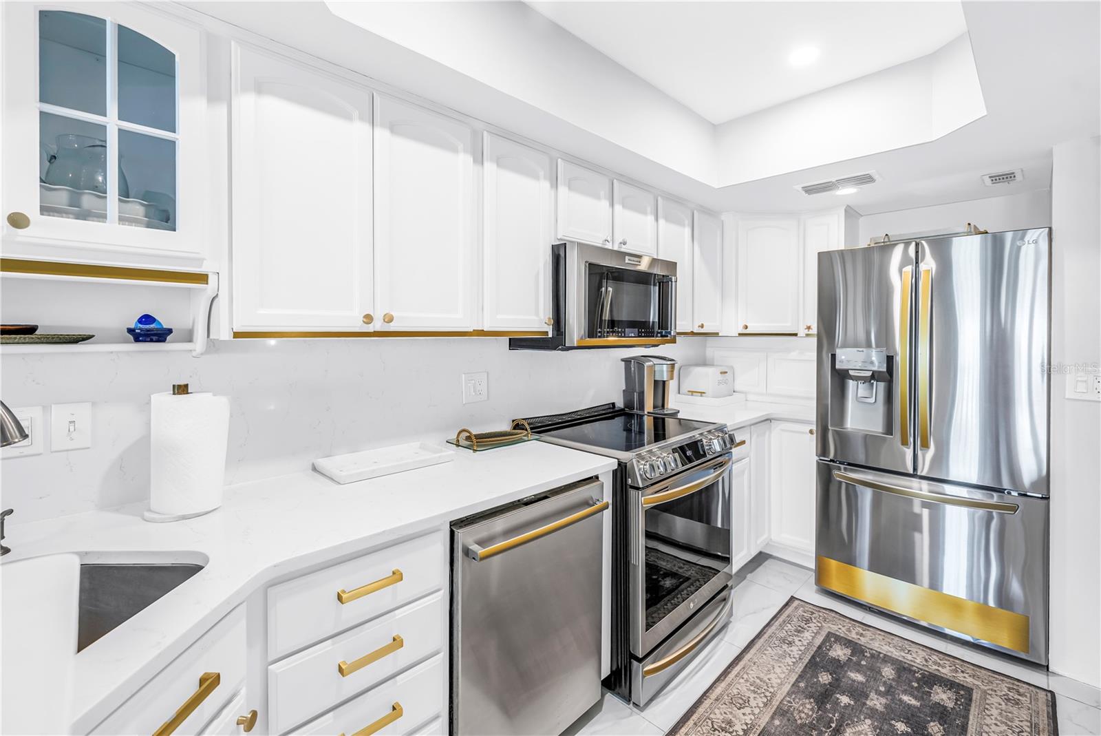 solid stone counters and gold accented kitchen