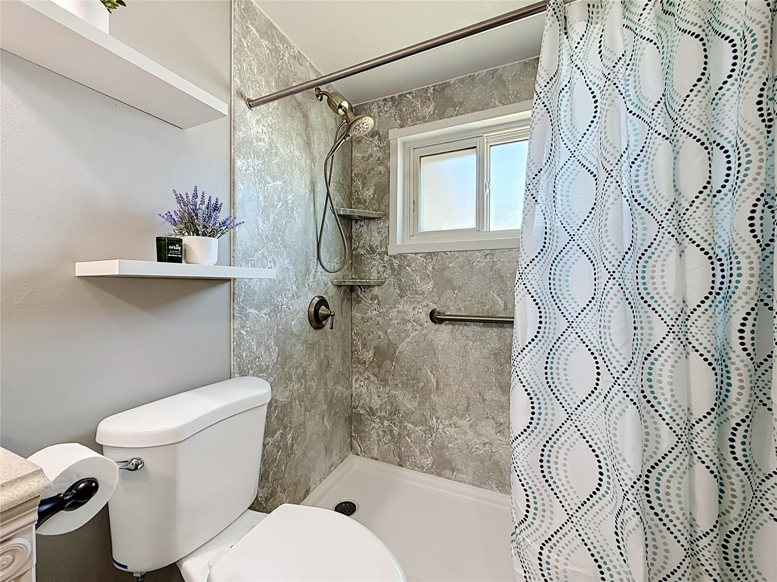 Remodeled Bathroom with new hurricane impact rated window and custom barn door