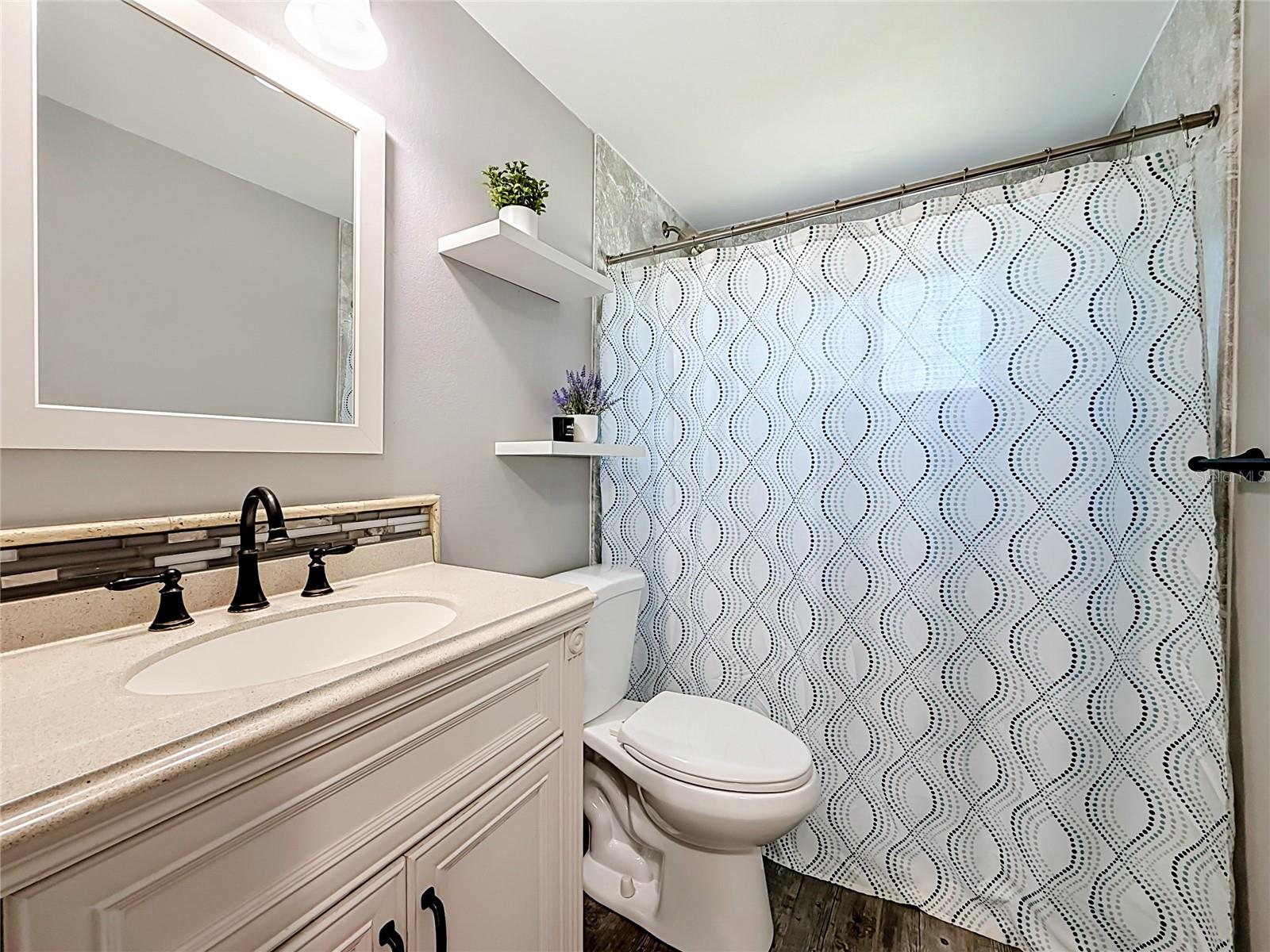 Remodeled Bathroom with new hurricane impact rated window and custom barn door