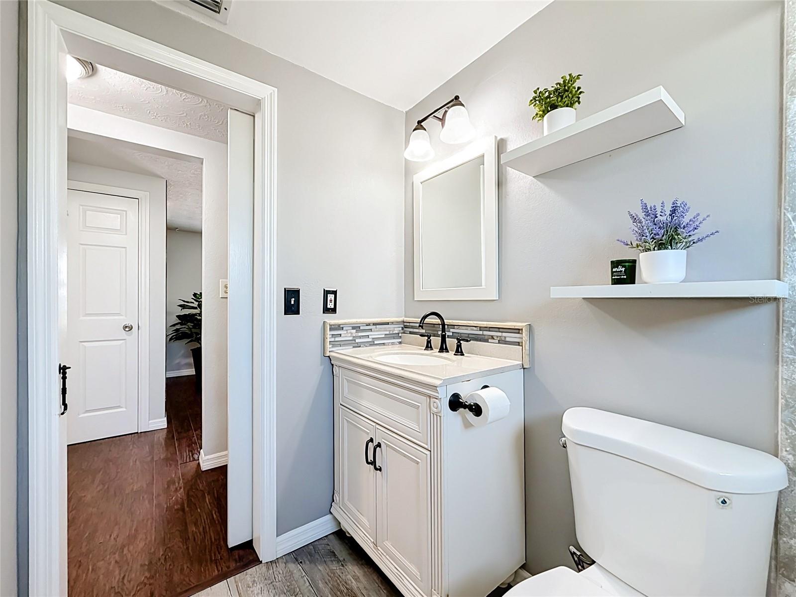 Remodeled Bathroom with new hurricane impact rated window and custom barn door