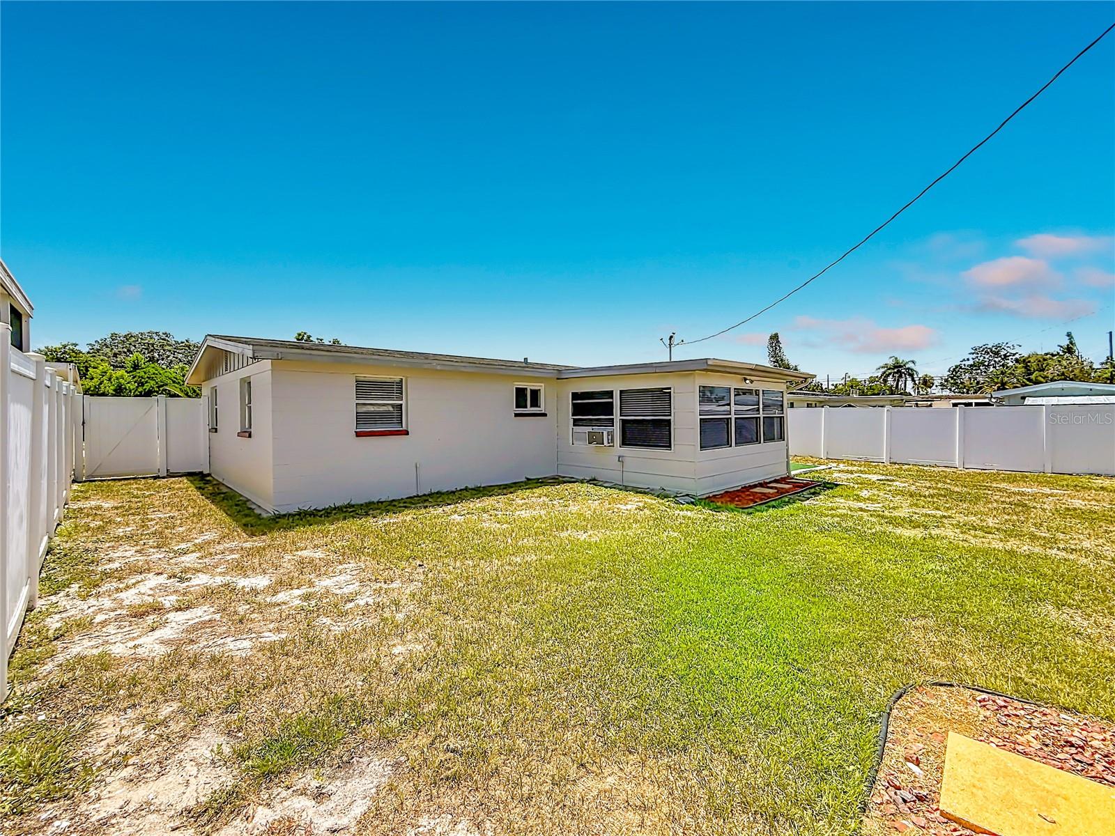Large fenced in backyard with patio and shed with electric