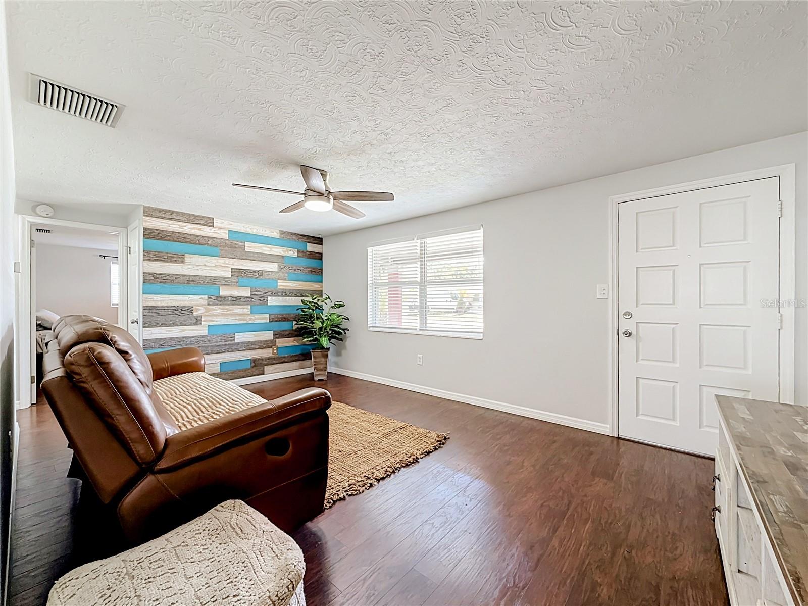 Living Room with custom wood panel accent wall
