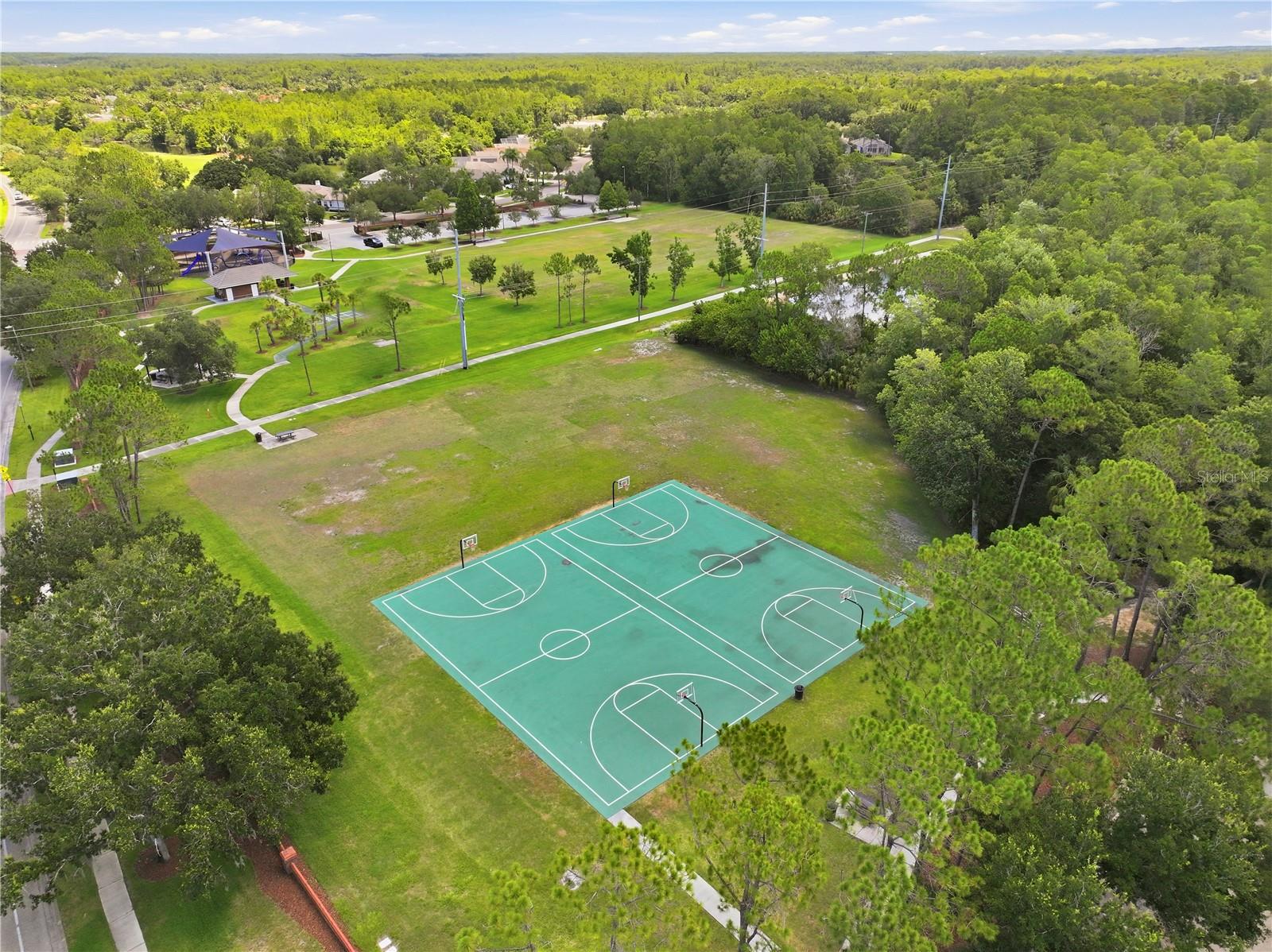 Basketball Courts and activity area with Glencliff Park to far left. Trails to the left of the basketball court.