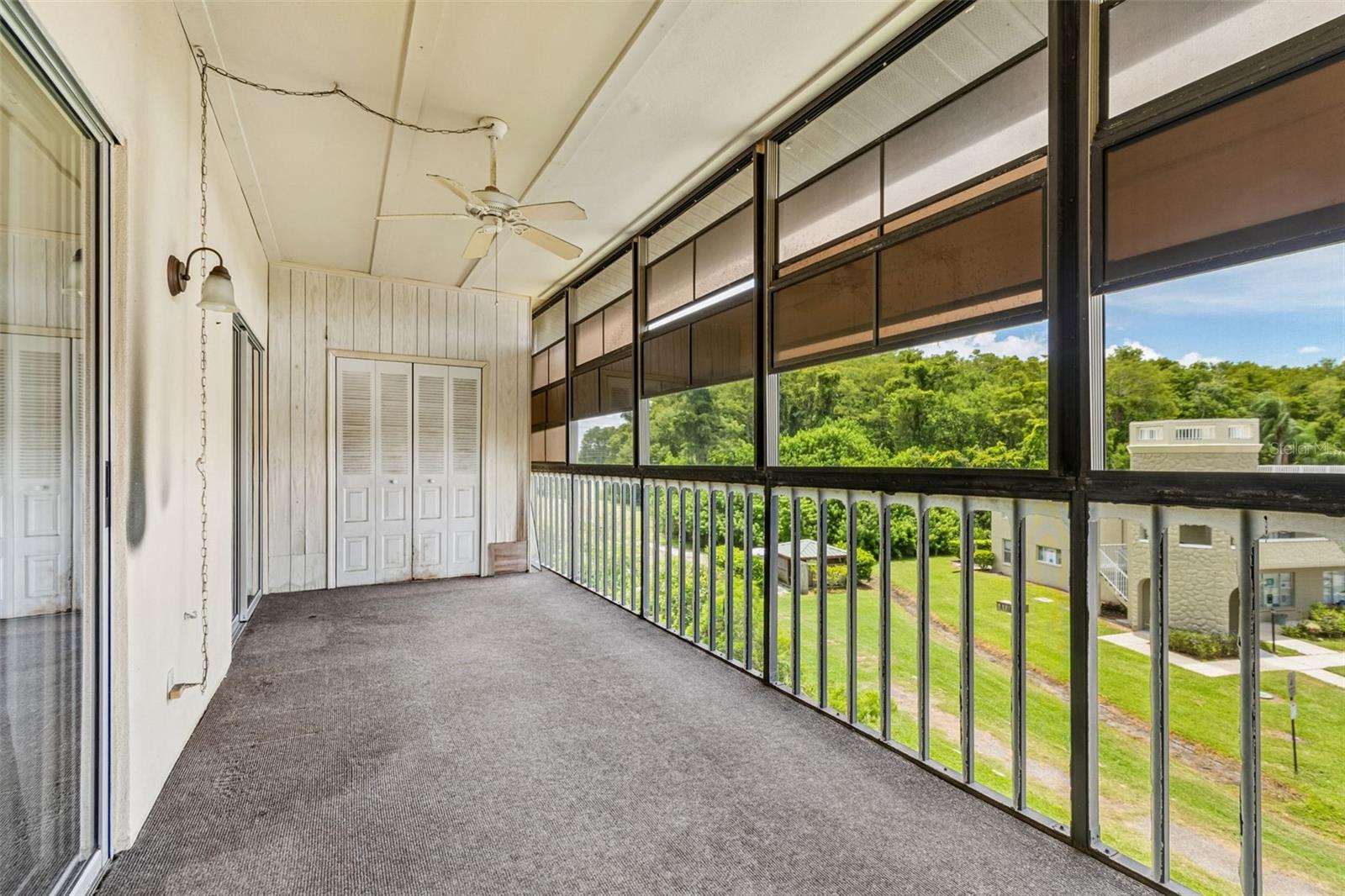 Florida Room with view toward storage closet and the 10th hold of OTOW golf course 10th tee.