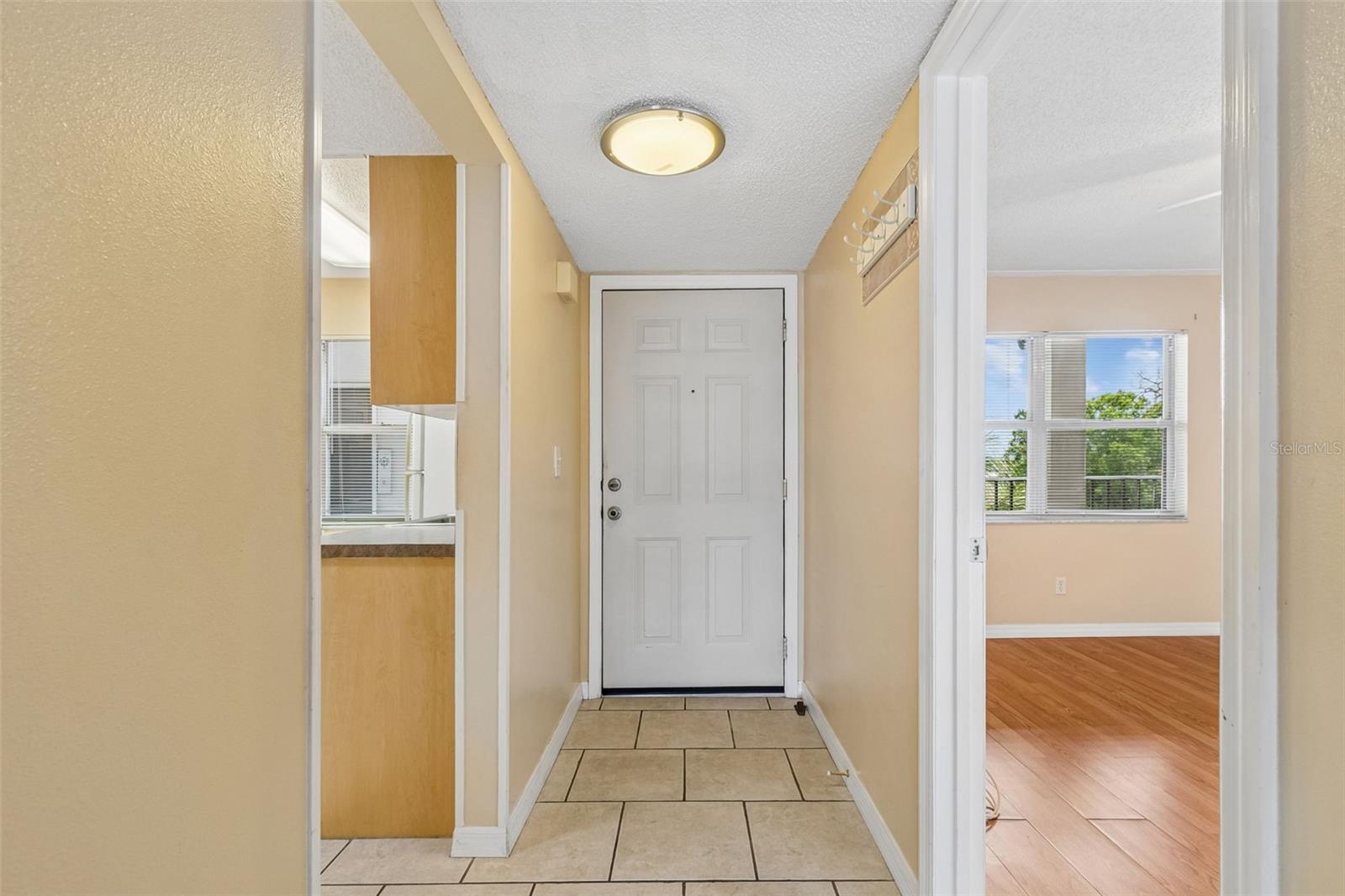 View from dining area to front door.  Kitchen on the left, 2nd bedroom on the right.