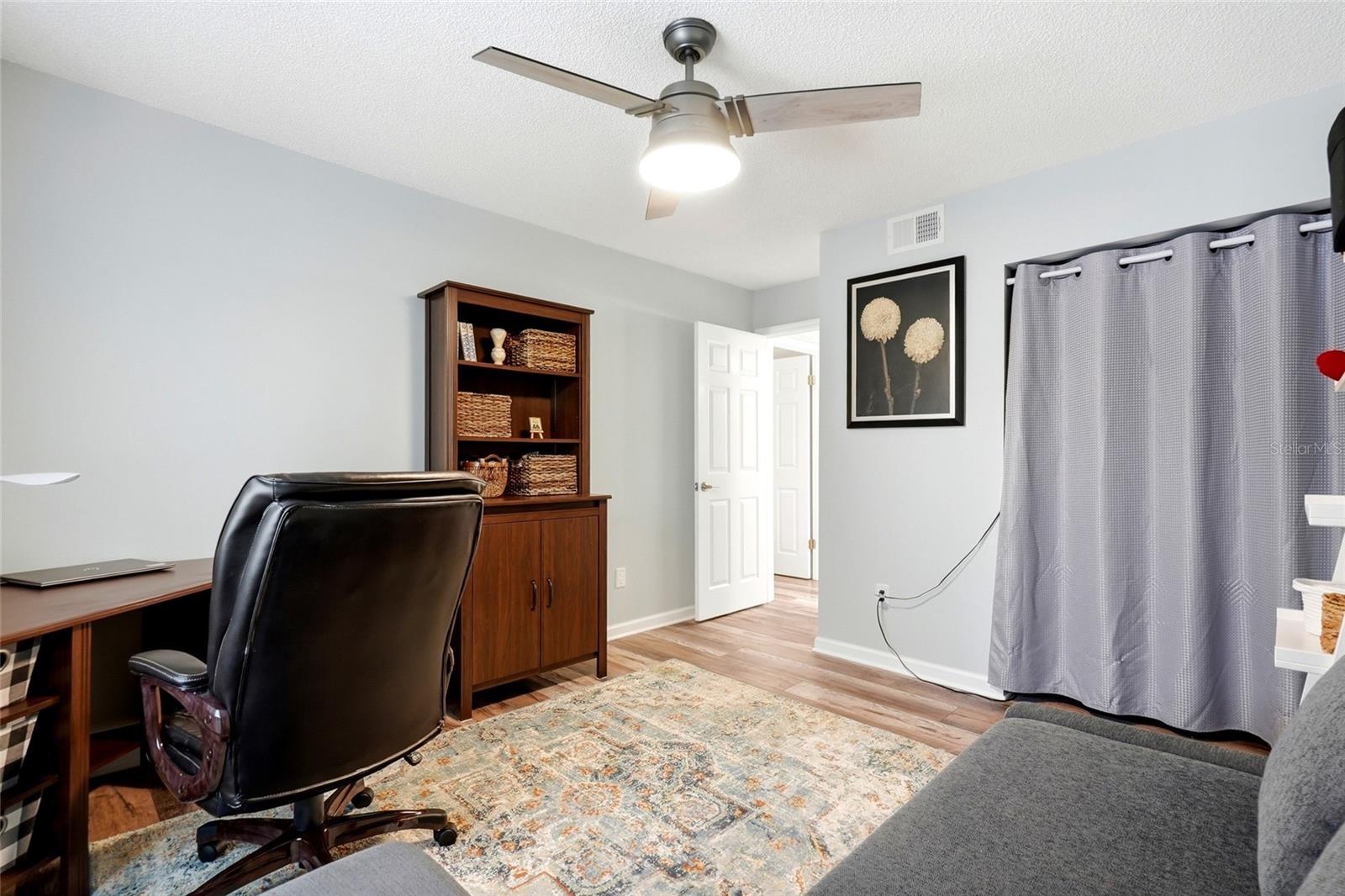 Bright and spacious second bedroom or office with abundant natural light