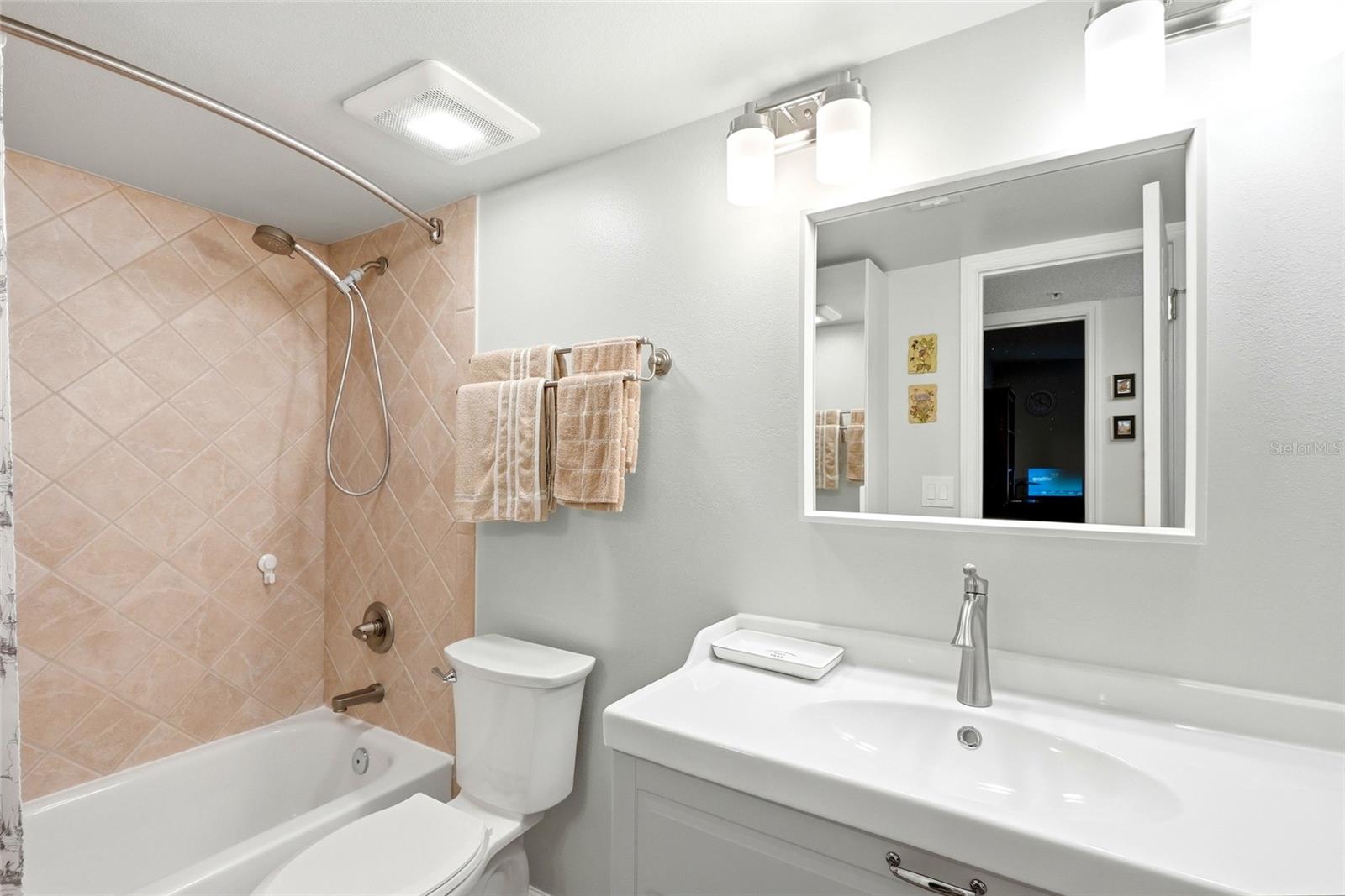 Full guest bathroom with tub/shower combination