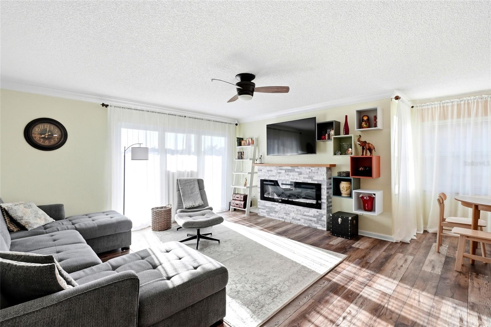 Spacious living room with a cozy wood-burning fireplace