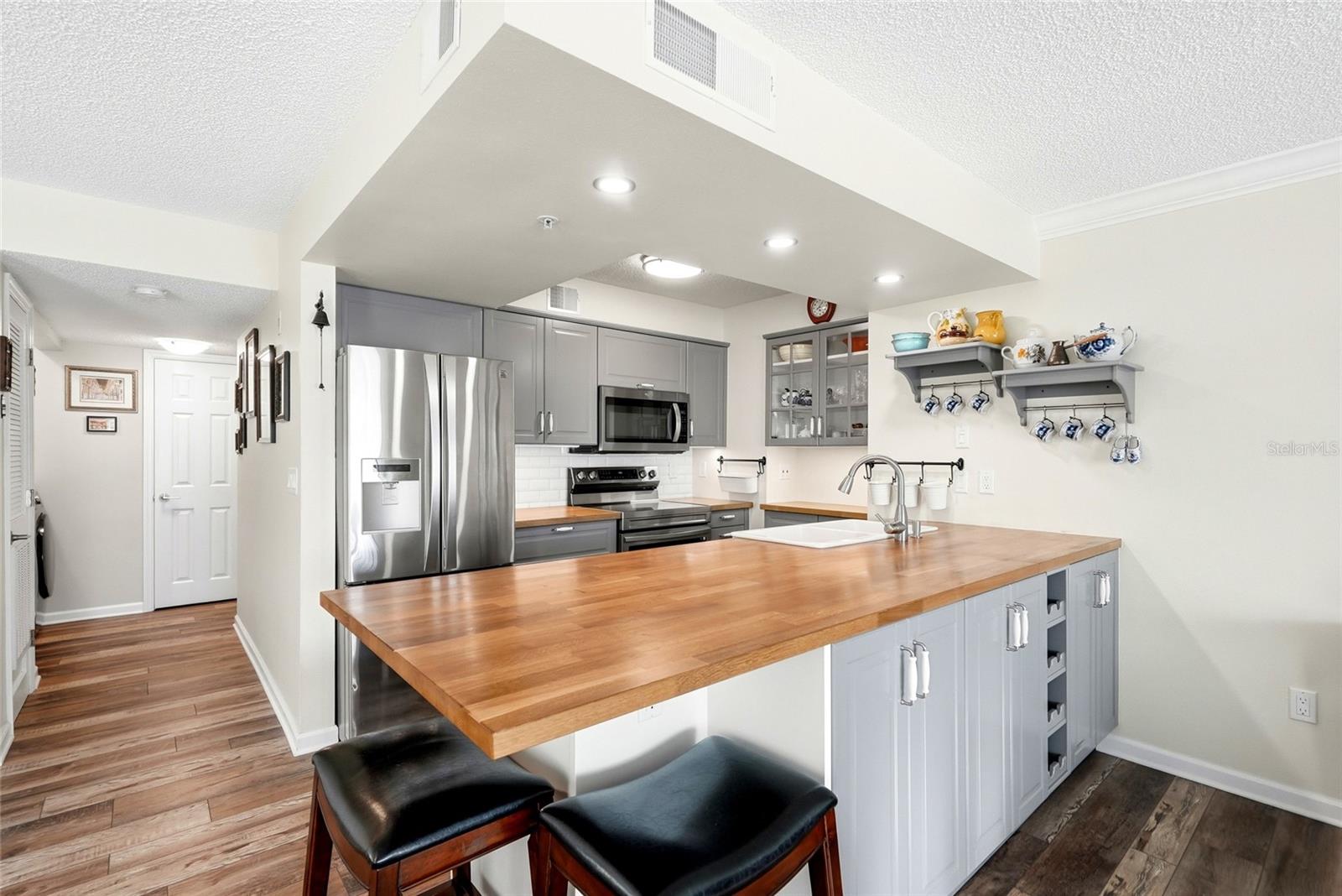 Remodeled kitchen with hallway leading to the laundry area and bedrooms