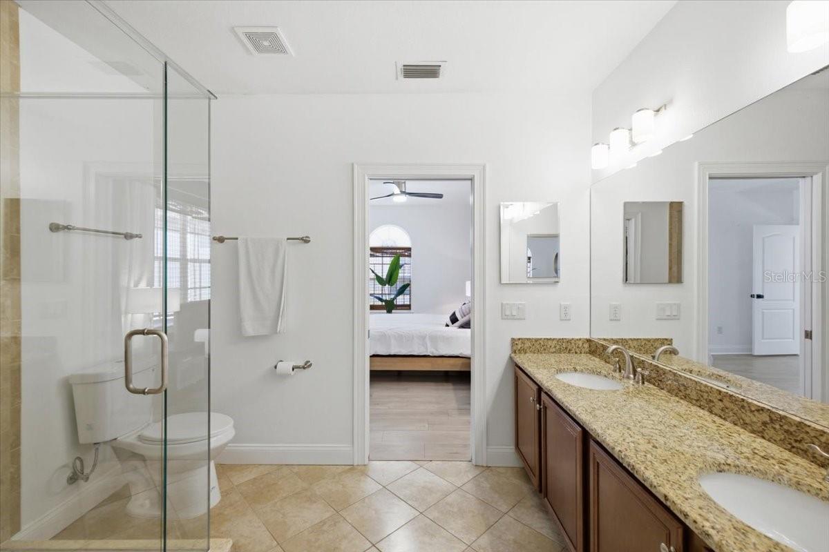 Large dual vanity and sinks, with oversized walk in shower in en suite bath.