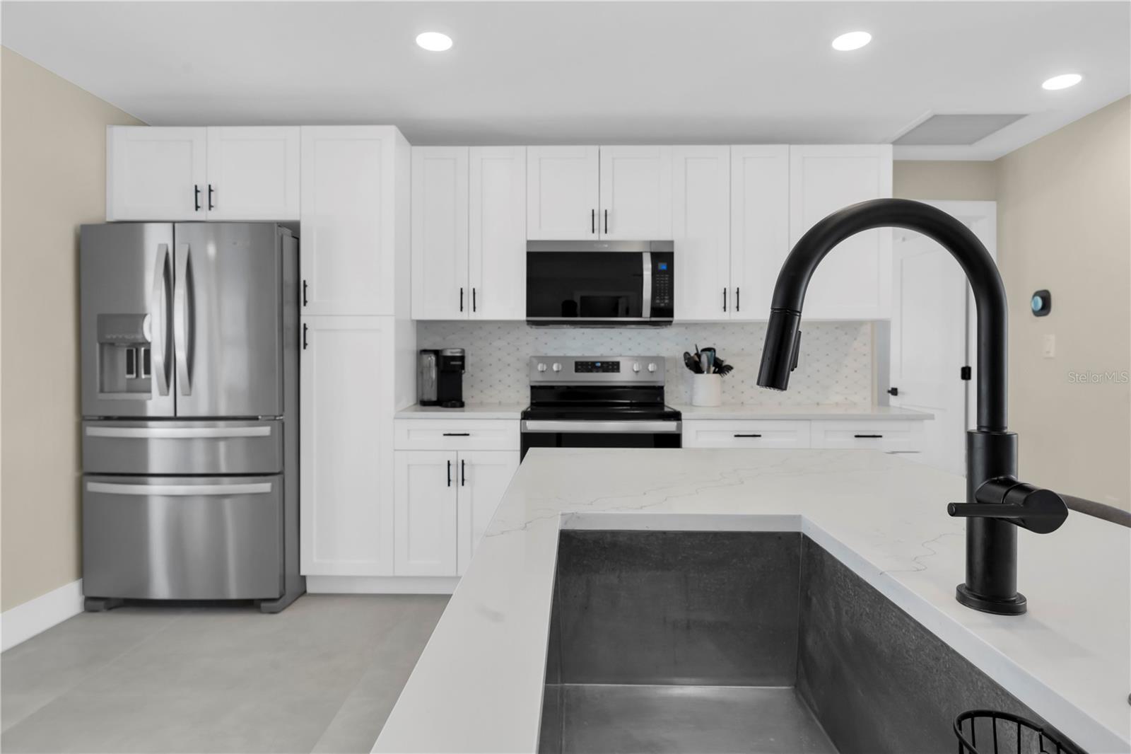 custom kitchen with ample storage and quartz surfaces