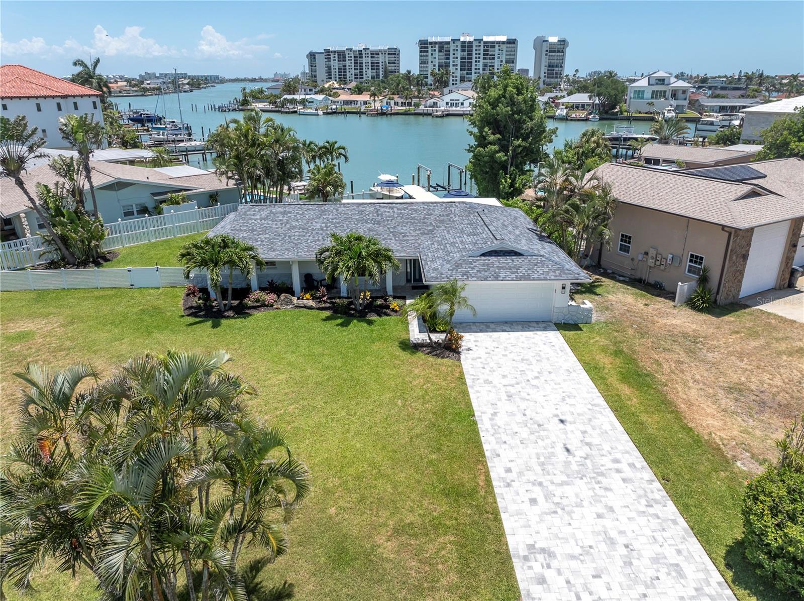 Deep pavered driveway, ample green space, wide water views