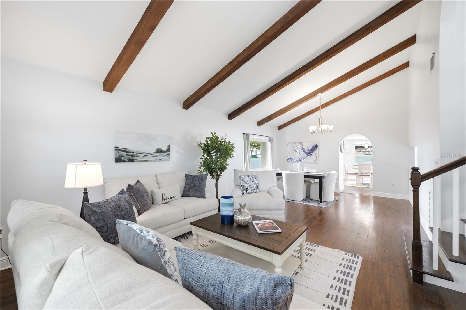 Gorgeous formal living and dining room with vaulted ceilings and solid wood beams