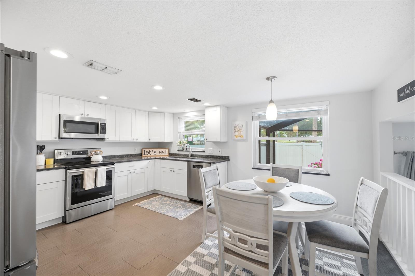 Updated chef's dream kitchen with granite counters and lots of cupboard space with a cozy eat in dining area