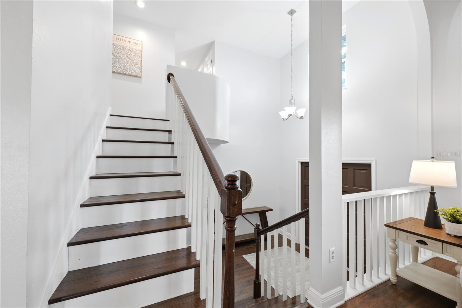 Custom built staircase leading to third floor bedrooms