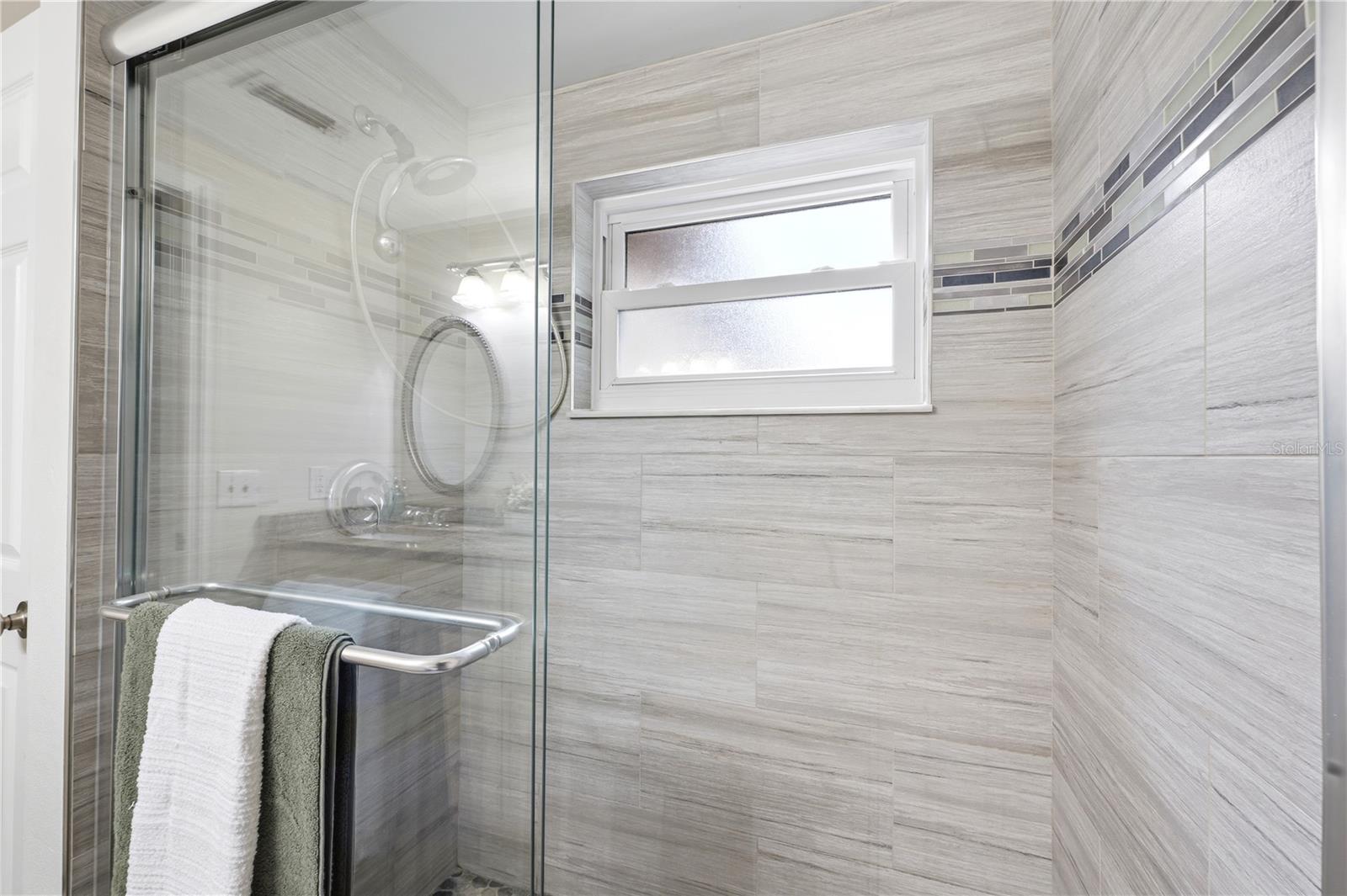 Floor to ceiling tile in the walk in shower