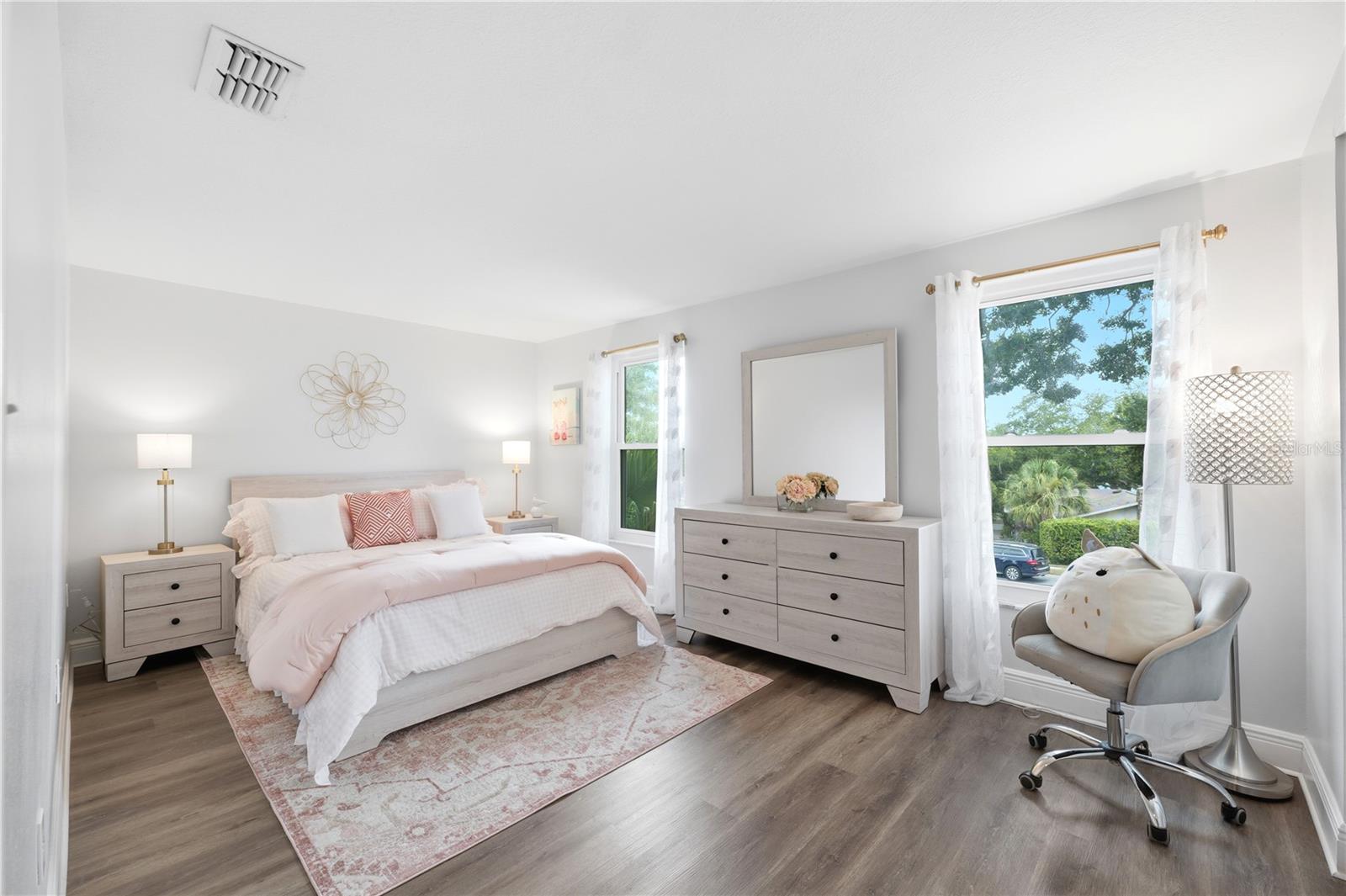Guest bedroom 2 with luxury vinyl flooring , and closet with custom built in shelving