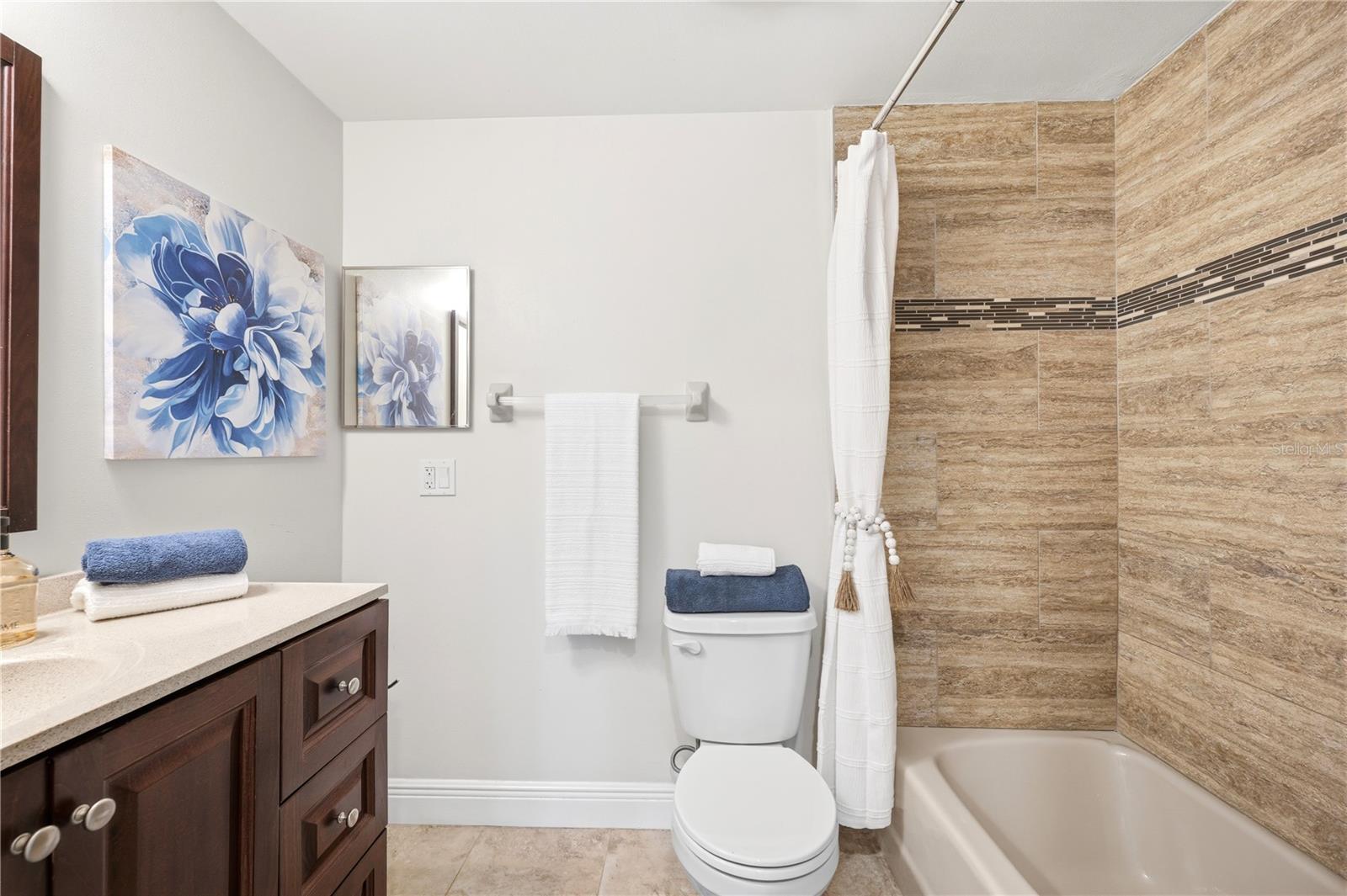 Third floor bathroom shared with 2 guest rooms, updated counters and tile surrounding tub