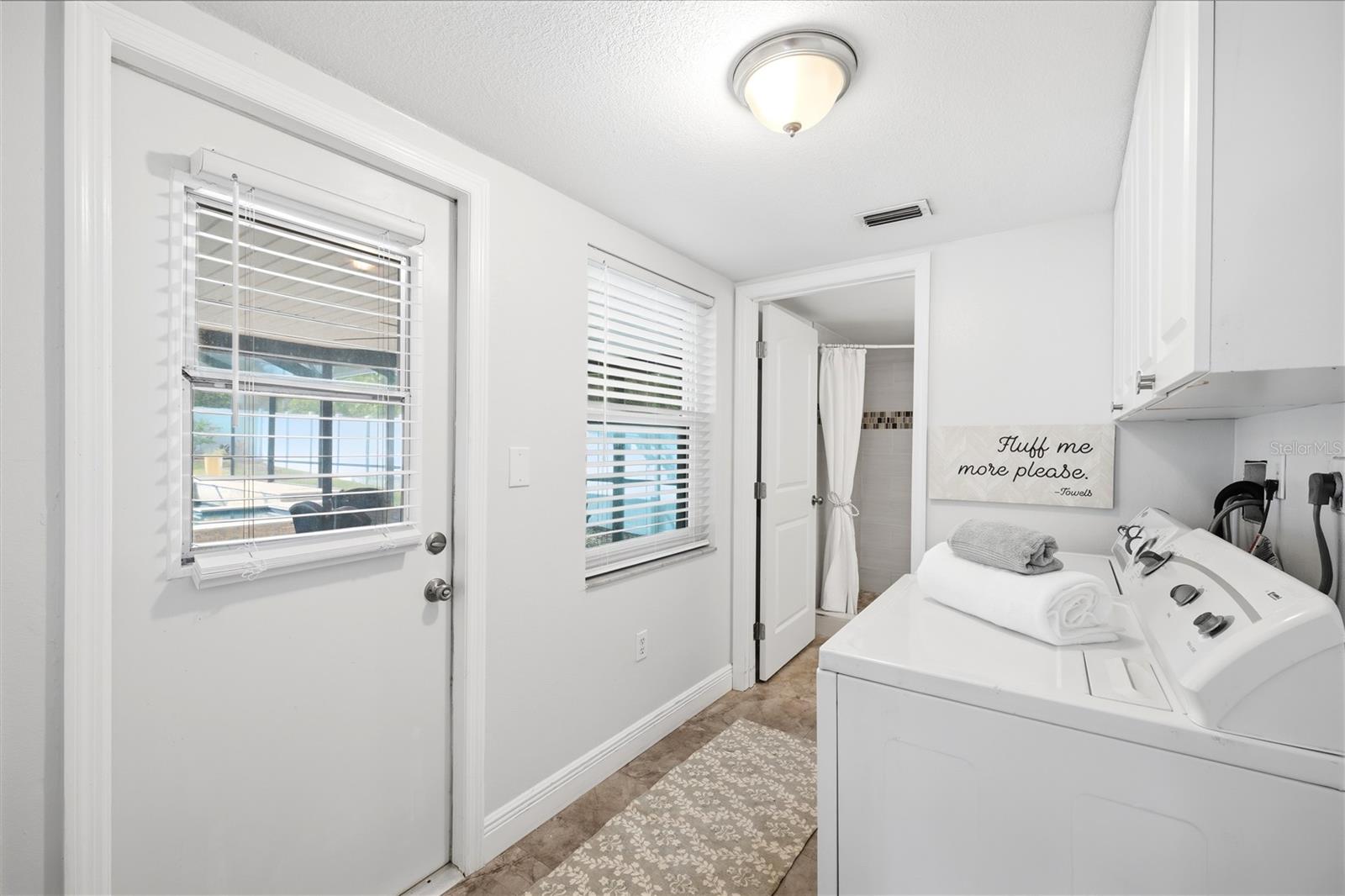 Large laundry room on first floor with walkout to pool