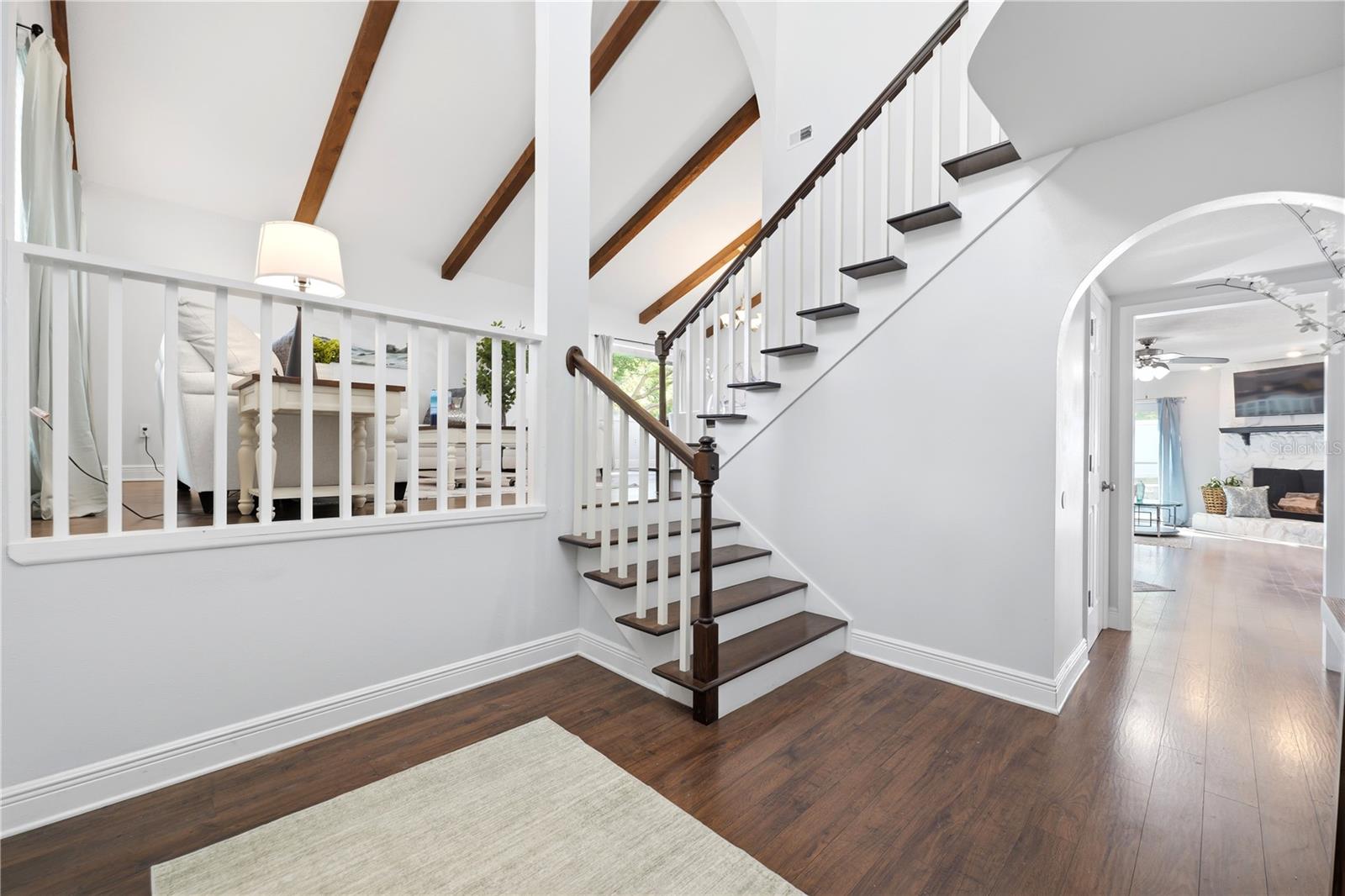 Large foyer with views of the second level and custom beam ceilings