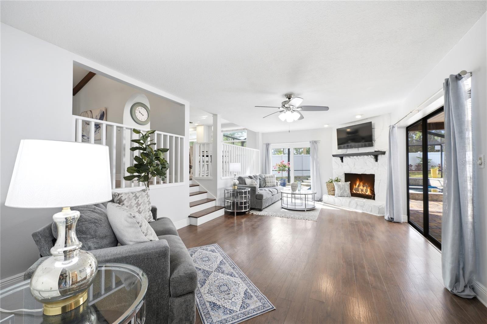 Huge split family room with a wood burning fireplace and walkouts to the pool and patio