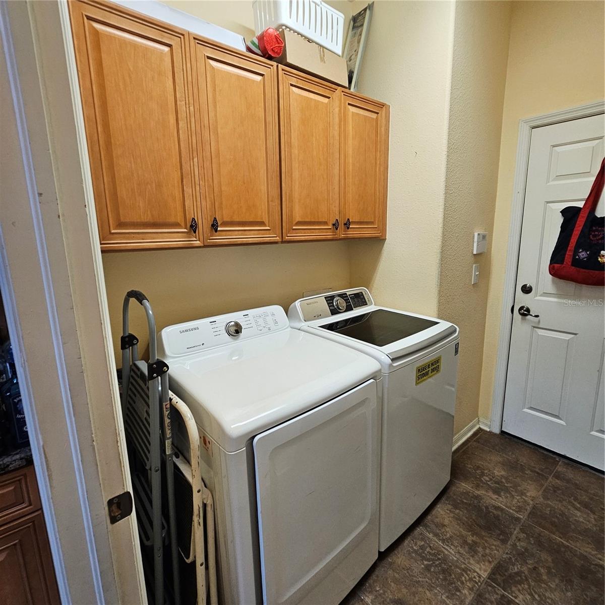 Inside Laundry room with storage