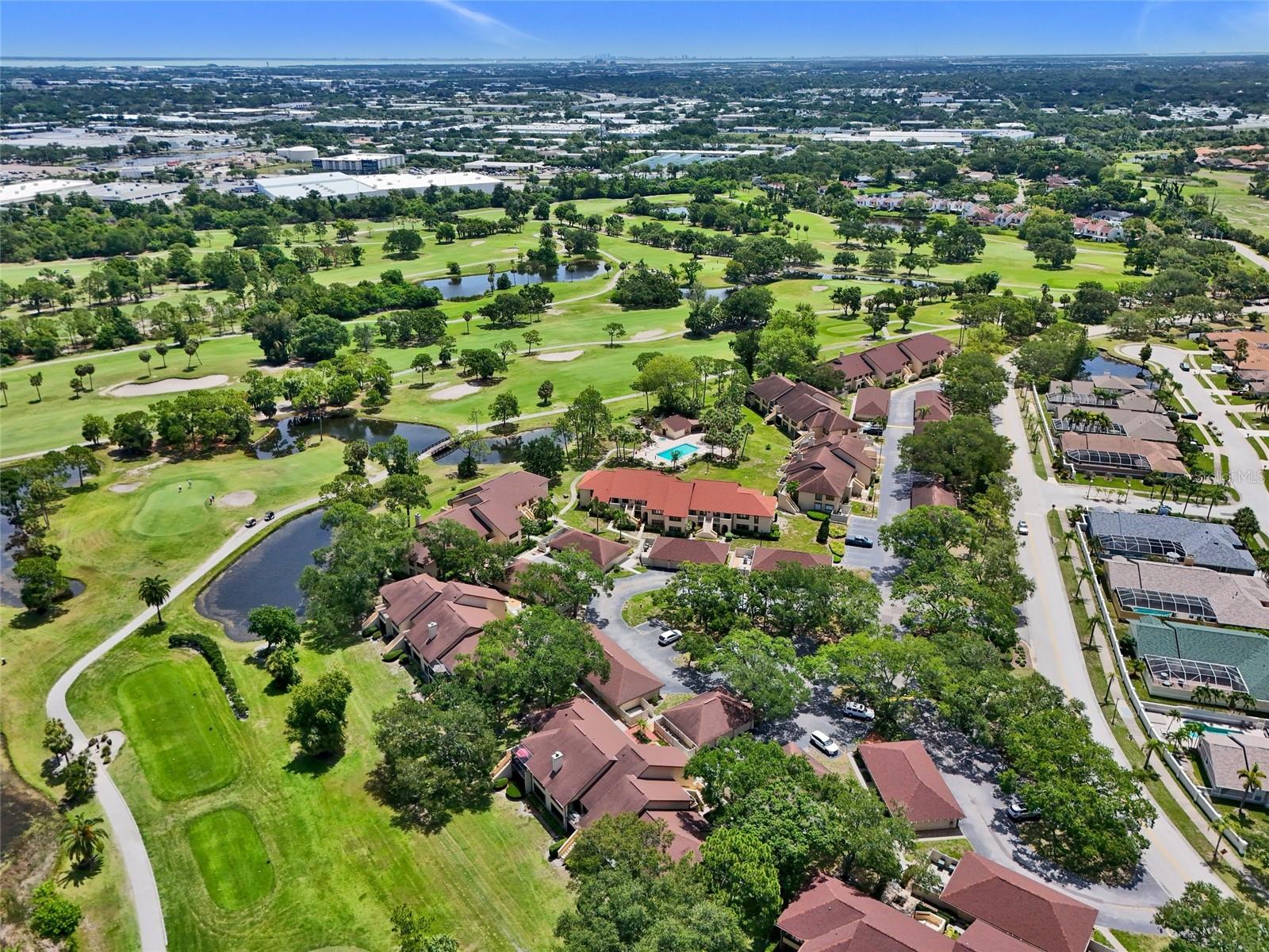Aerial view of community with pool and spa in the middle of the photo