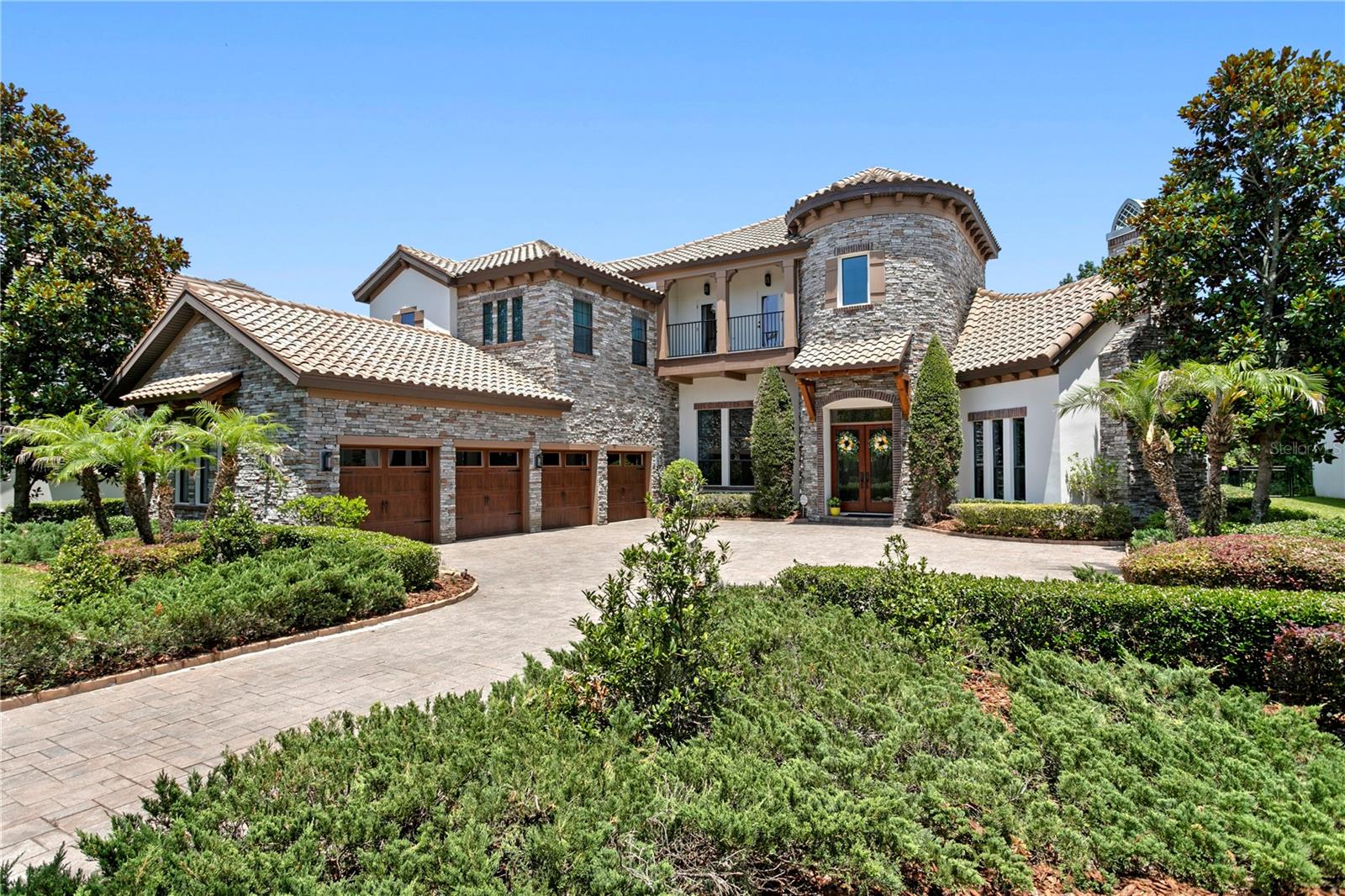 Stunning architectural design with elegant stone and stucco finishes.