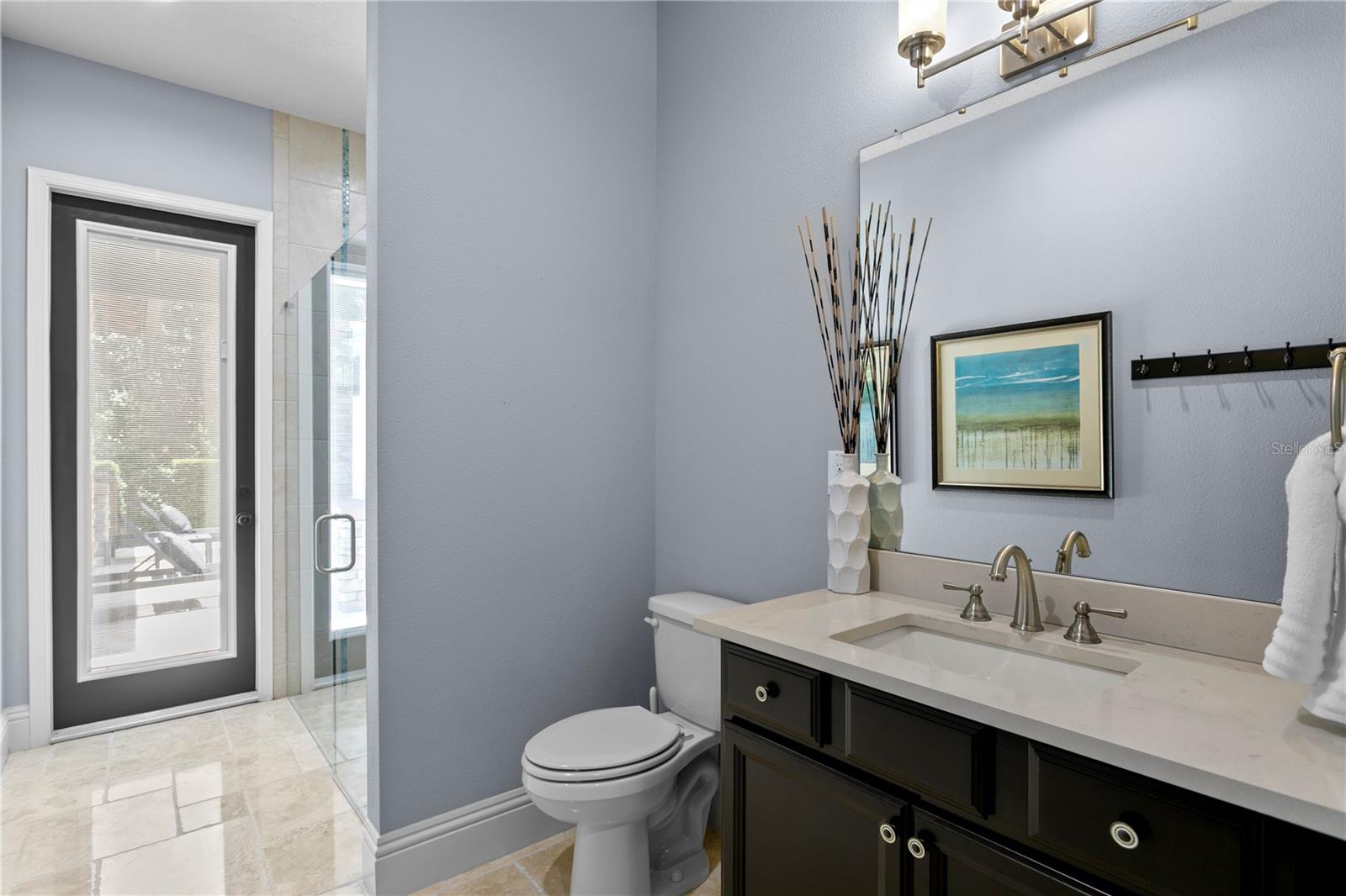 Full bathroom with access to pool area.