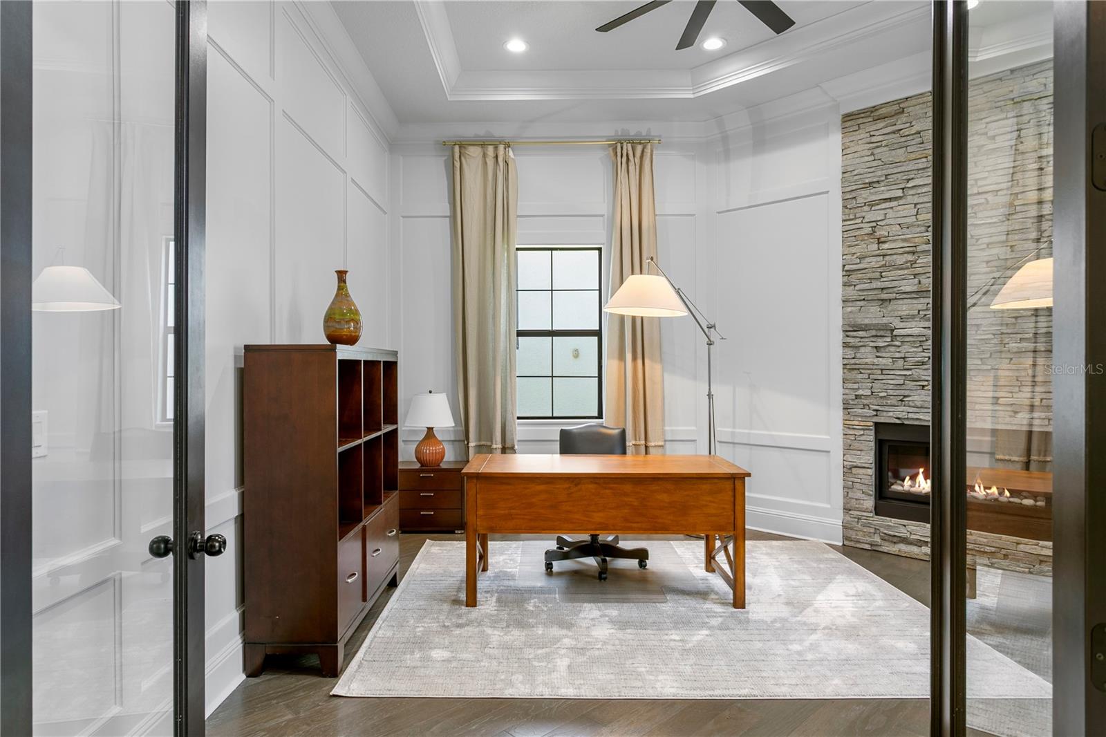 Office room with elegant fireplace.