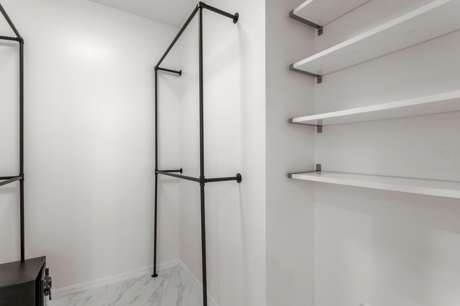 Primary bedroom walk in closet -1