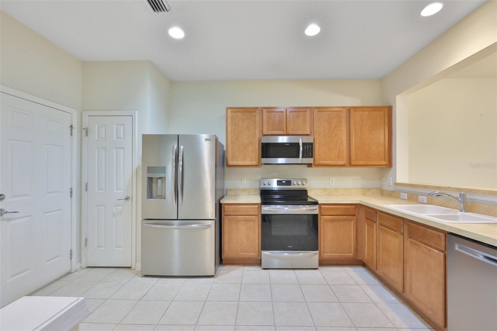 Door to garage, pantry, recessed lights overhead for a nice bright kitchen!