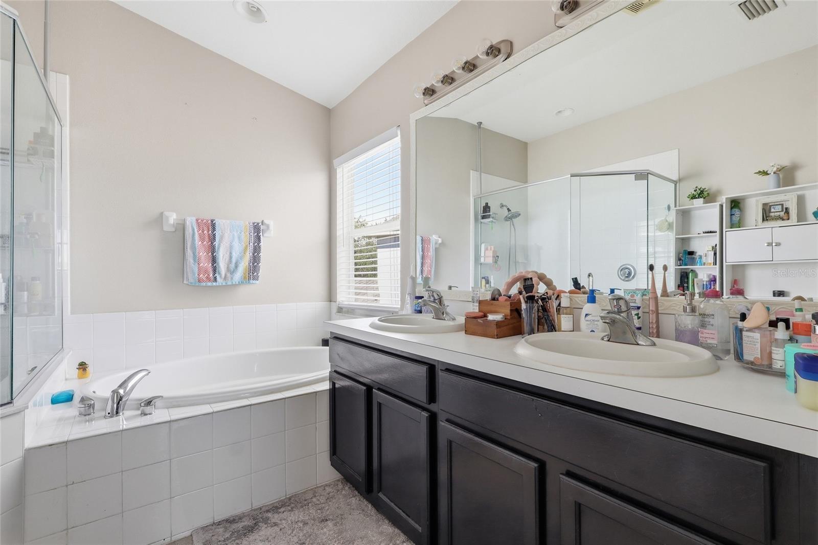 Primary ensuite with double vanity, dual sinks and garden soaking tub
