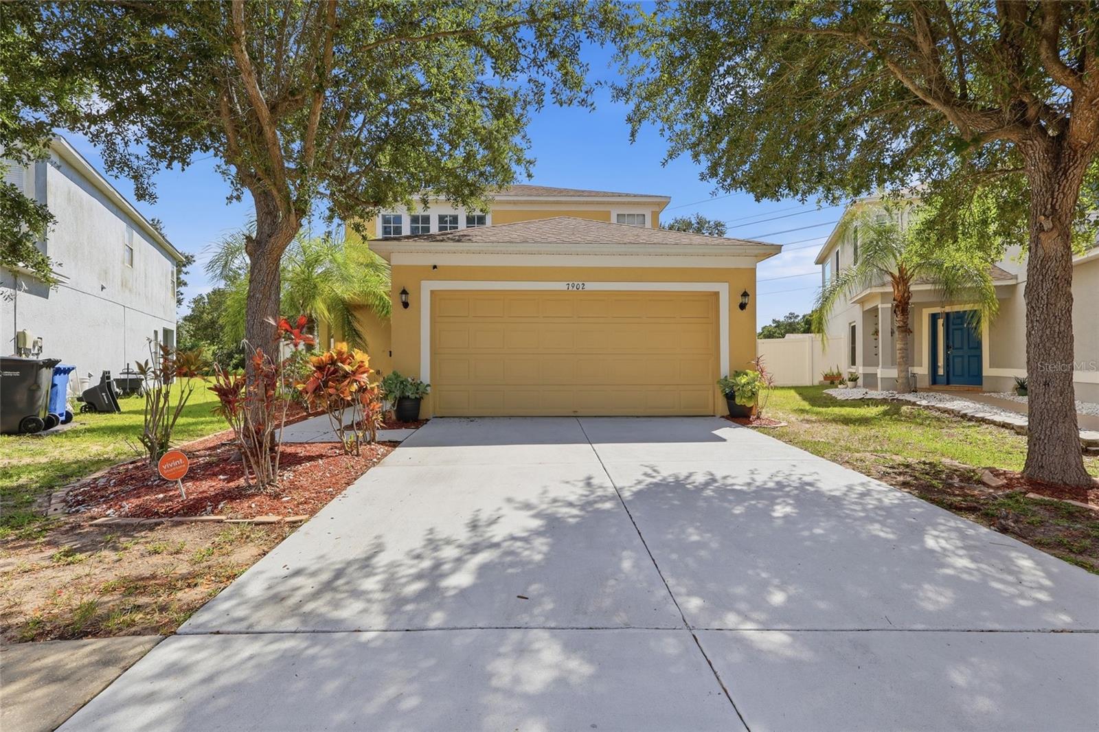 Florida single family home with 2-car garage and mature landscaping