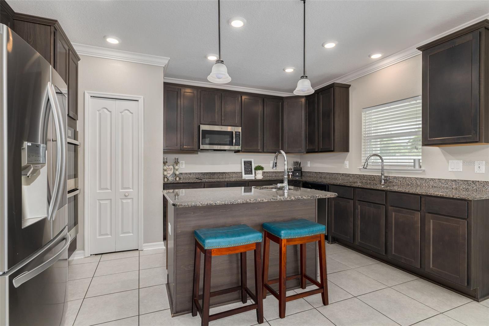 Large Island with seating, cabinets and produce sink.