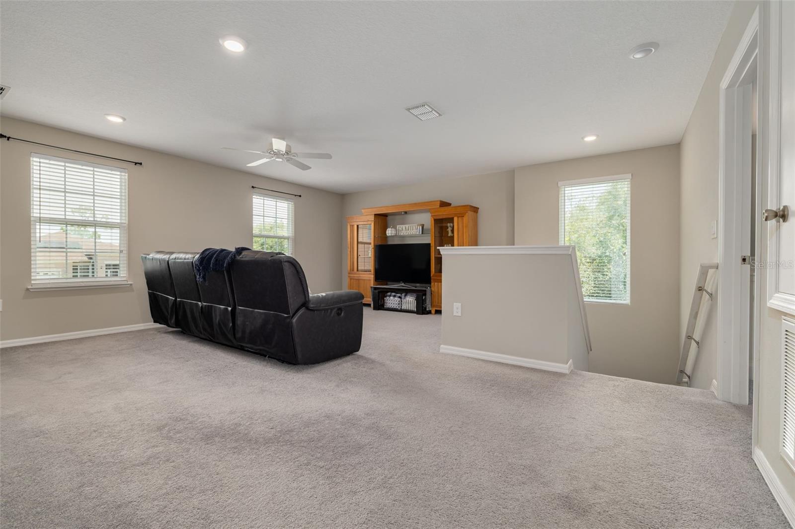 Expansive loft perfect for a media room, game room, or additional living space.- Upstairs