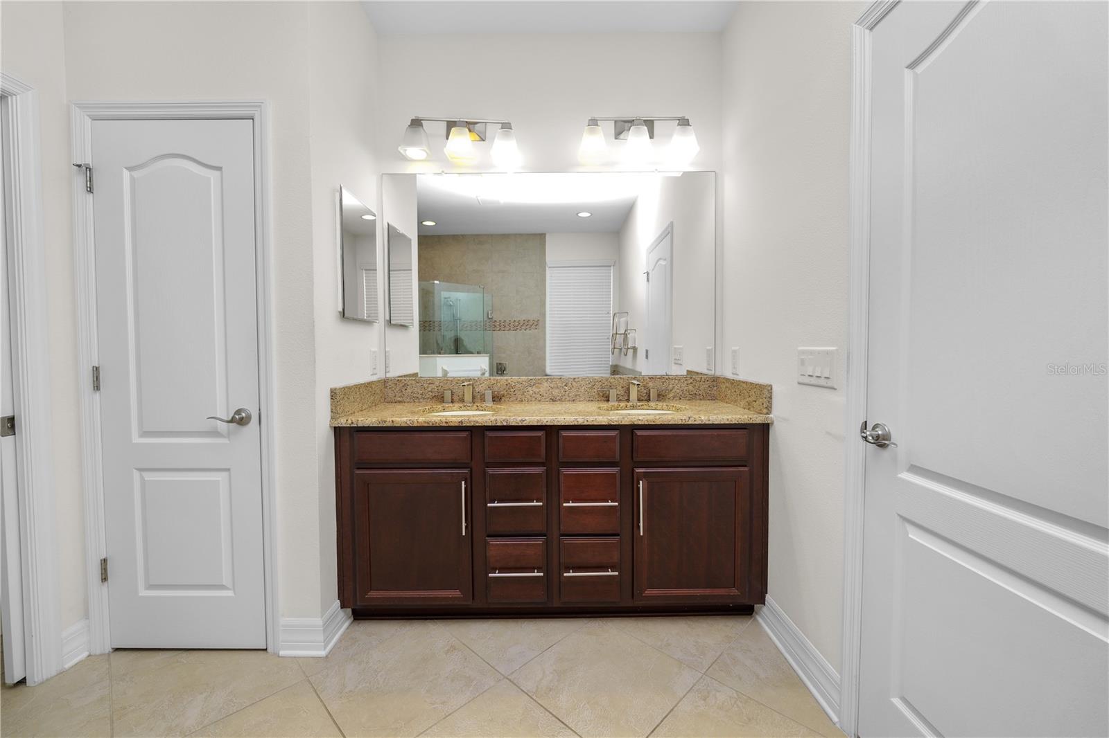 Primary Bath with a Double Sinks Vanity and Drawers for Storage, and a Convenient Linen Closet