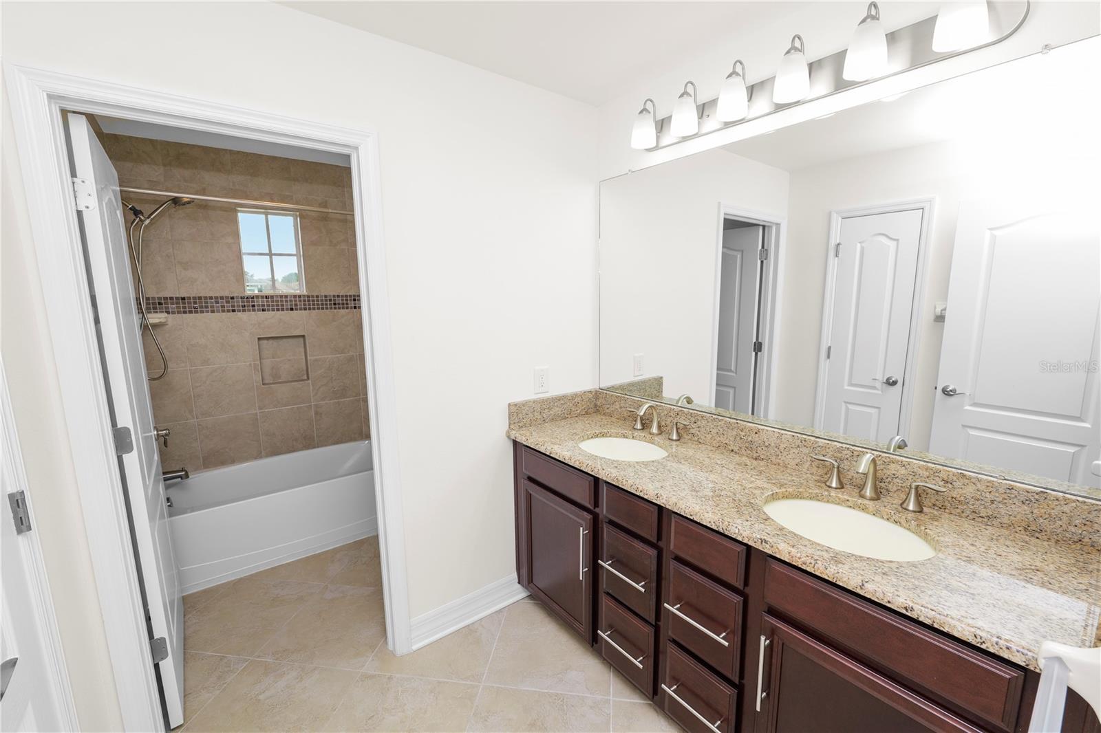 Second Level Bathroom with Double Sinks and Separate Shower Room