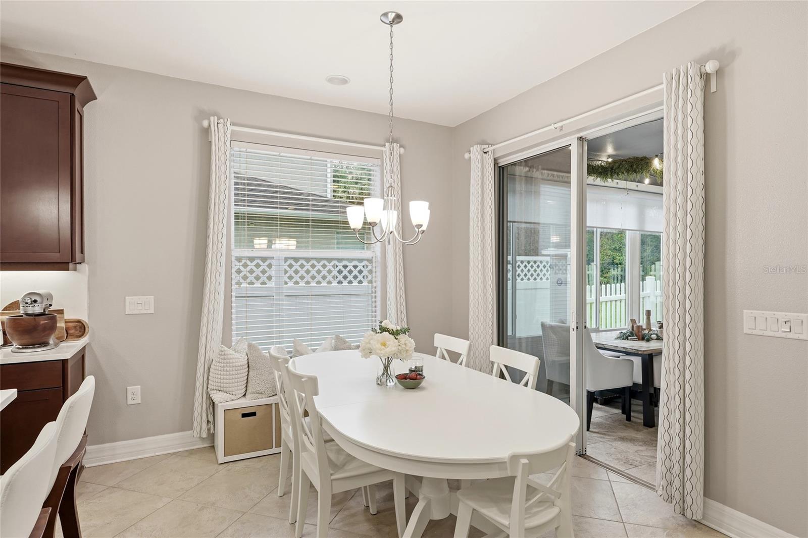 Eat in Kitchen with Large Window and Sliding Glass Doors Leading into Sunroom