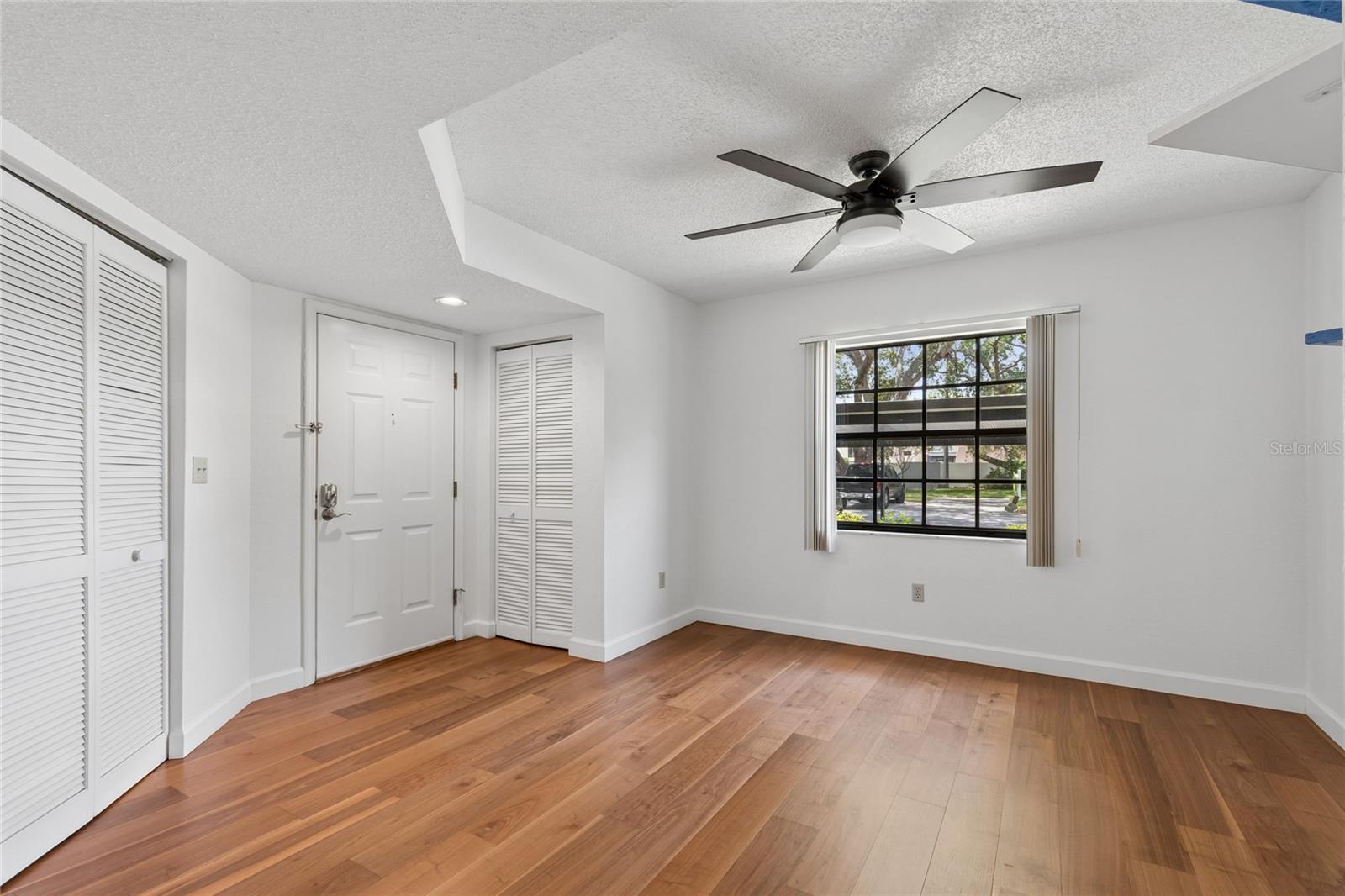 View inside and looking to entrance door and closet areas